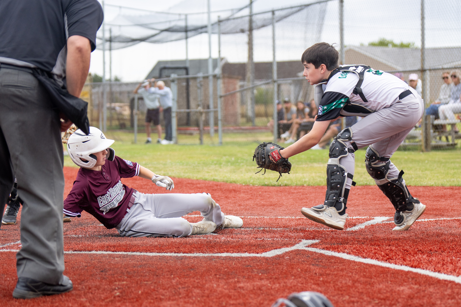 East End catcher Gabe Dawson awaits an incoming throw to the plate.   RON ESPOSITO