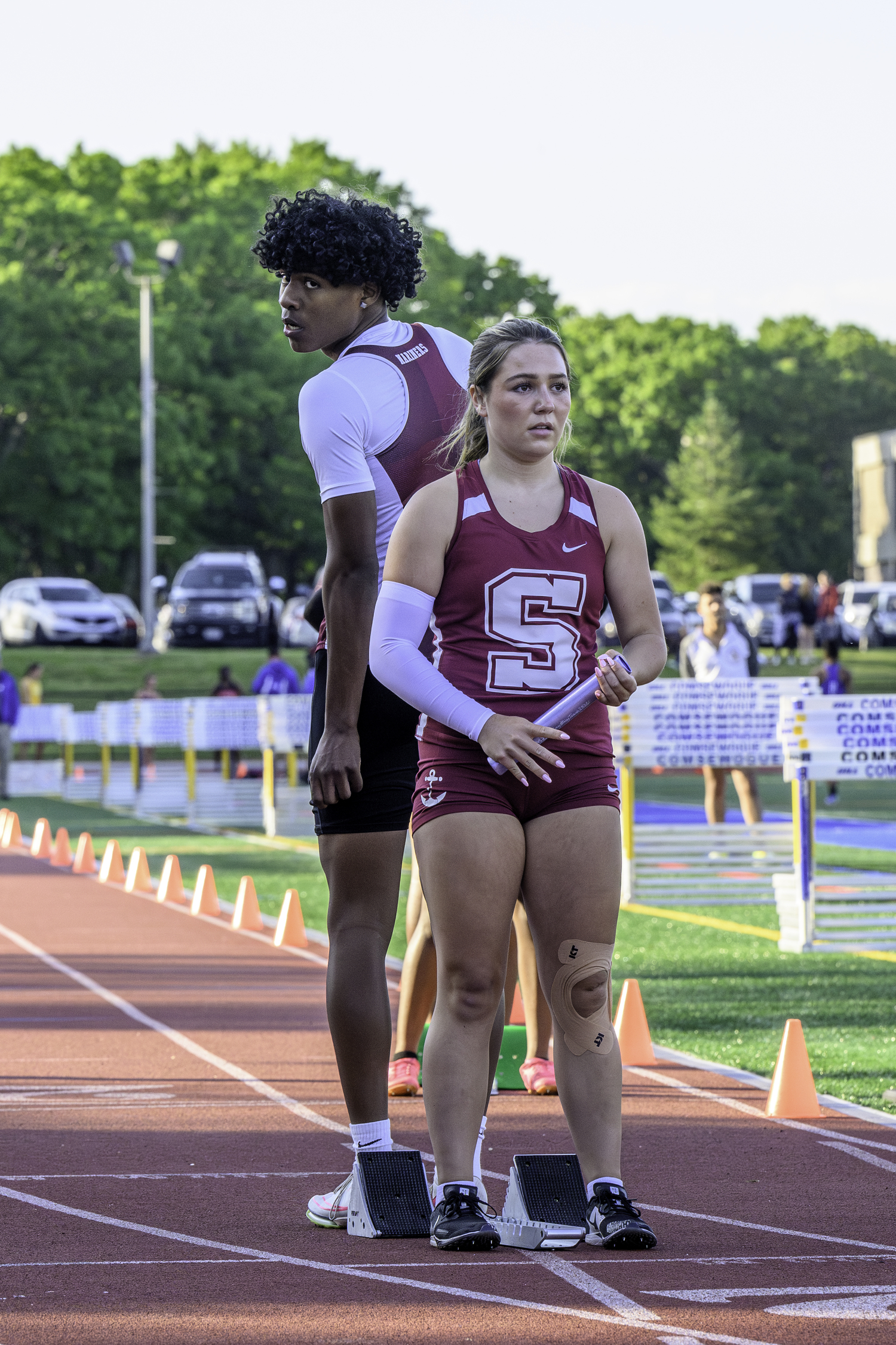 Dominick White stands on the blocks for Katie Terry at the start of the girls 4x100-meter relay.   MARIANNE BARNETT