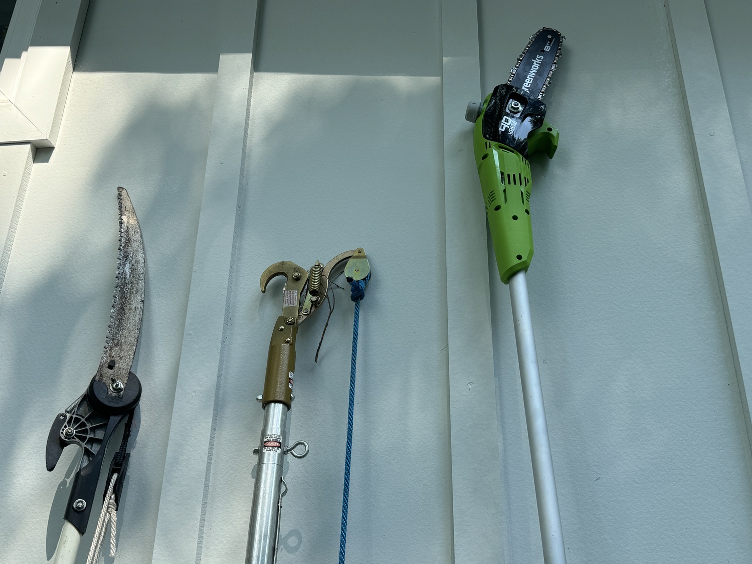 The working ends of the three tools. The loppers
and manual saws get more difficult to work with as you extend them. The Greenworks battery pole saw requires little effort even when fully extended and makes smooth, straight cuts. Read the manual and keep it oiled. ANDREW MESSINGER