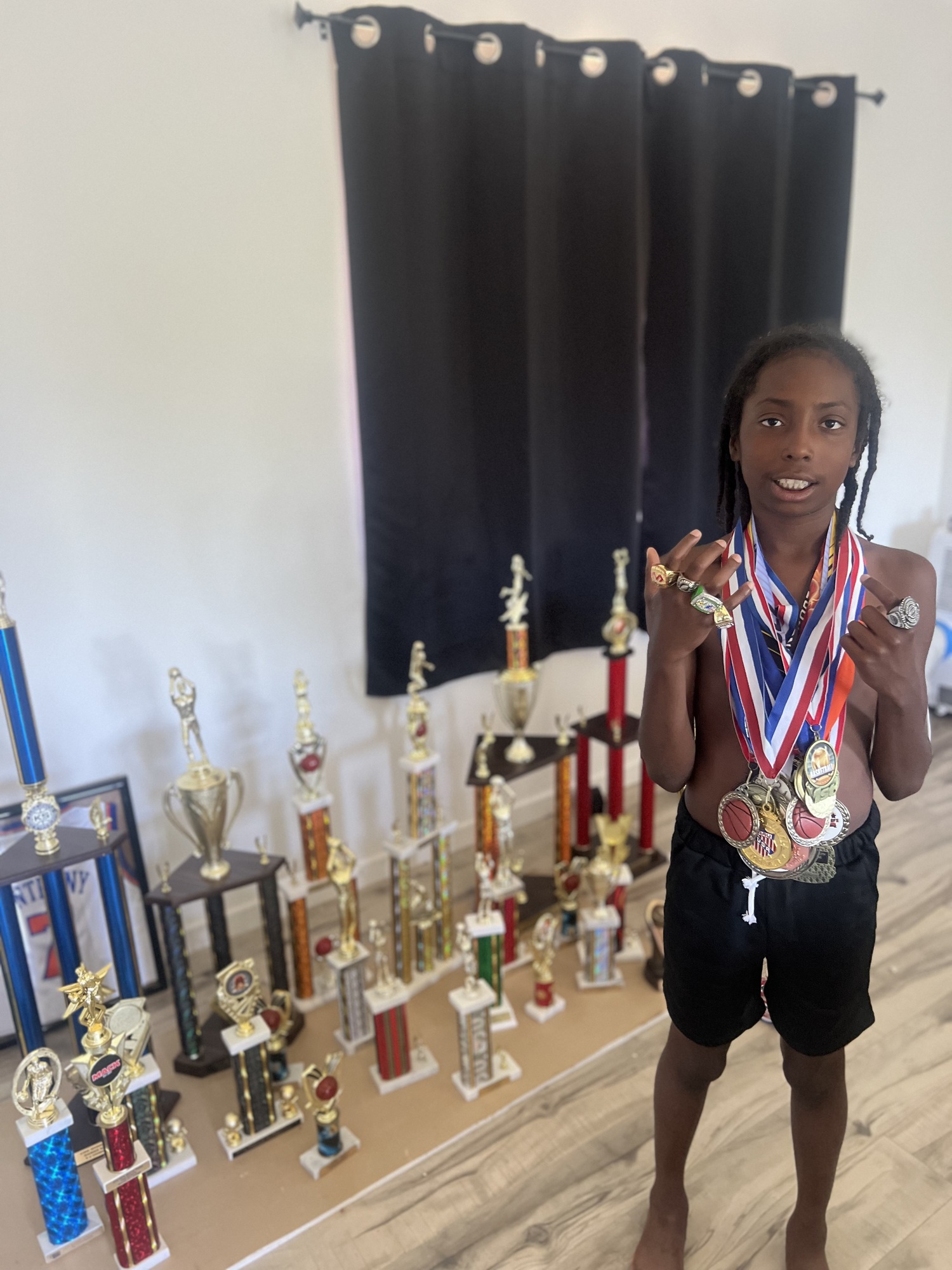 Nas McCoy's room in his Shinnecock home is filled with medals and trophies, some as tall as he is.
