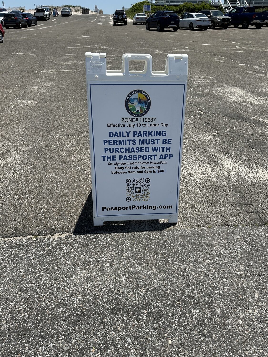 One of the foldable signs at Tiana Beach showing how to buy daily parking passes. DAN STARK