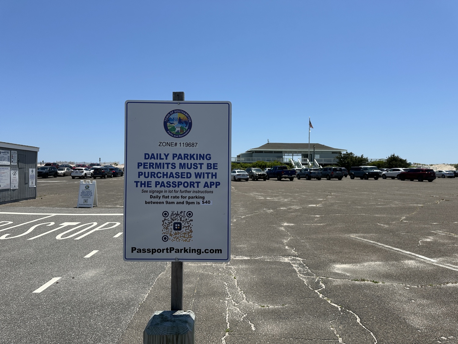 One of the signs with the QR code to scan to purchase daily parking passes at the entrance to Tiana Beach. DAN STARK