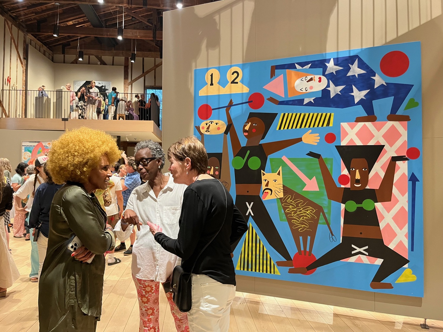 Artist Renee Cox speaks with Sheila Batiste and Beth Troy in front of Nina Chanel Abney's 