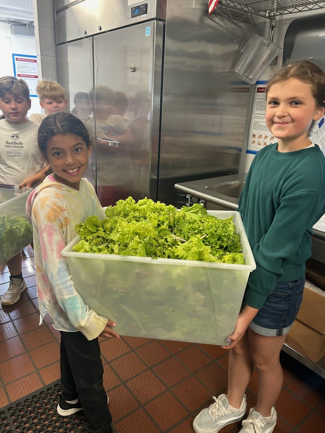 Southampton Elementary School Gardening Club members recently hosted their first farm-to-table lunch at their school. For the lunch, the students planted and cared for lettuce seeds in their school’s indoor tower garden and outdoor garden. Their harvest was served for lunch with the assistance of kitchen staff, who washed and prepped the lettuce. COURTESY SOUTHAMPTON SCHOOL DISTRICT