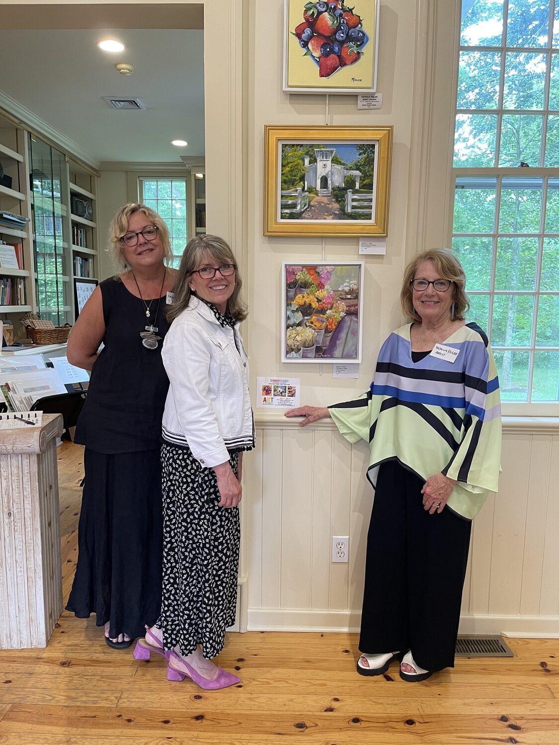 The latest Art Remsenburg show at the Remsenburg Academy — “Summer’s Here” — featured the works of three artists — Debra Foglia, Trisha Feiler and Diane White — all of whom were at the exhibit’s opening on Saturday June 22. COURTESY MARGARET BRUSH