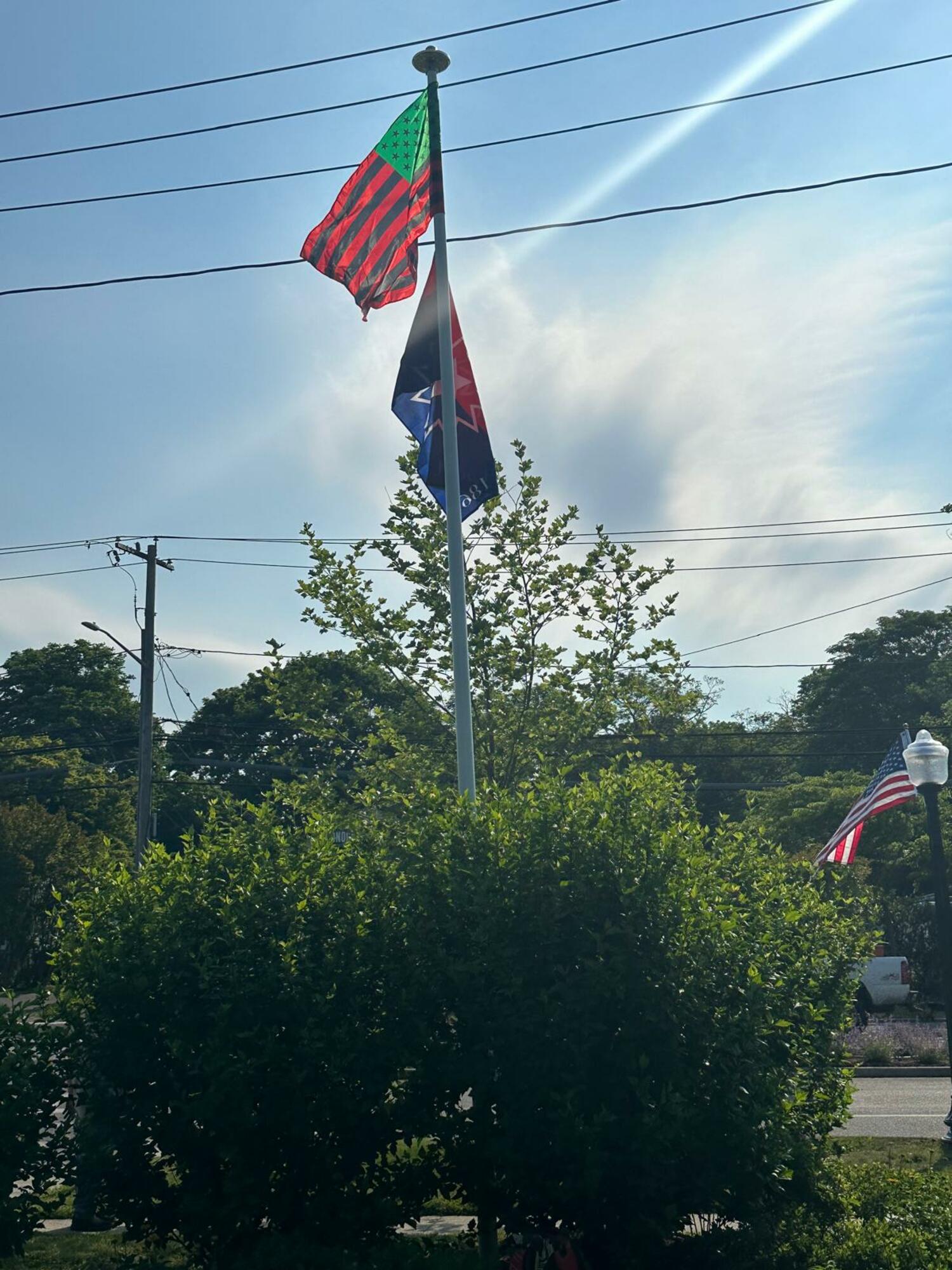 The red, black and green Pan-African flag, also known as the Marcus Garvey flag, and the red, white and blue Juneteenth flag, are now flying at the Southampton African American Museum. COURTESY SAAM