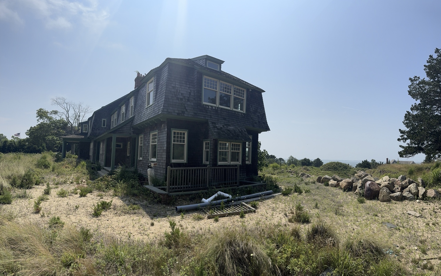 Historic preservationists have asked Southampton Town to landmark the Shinnecock Hills home that once belonged to Grosvenor Atterbury, but not where it stands now. The site is adjacent to Sugar Loaf hill, sacred ground to the Shinnecock Nation that used the region's highest points as burial grounds for centuries and the Peconic Land Trust, which now owns the land, has proposed relocating the house off the top of the hill. MICHAEL WRIGHT