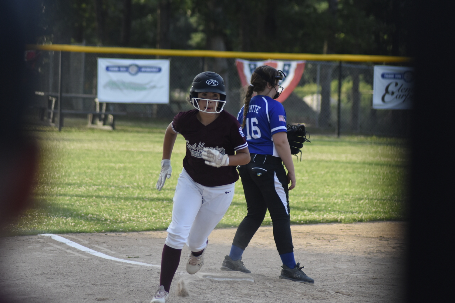 Kenzie O'Connell rounds third base and heads home on Novella Dunham's double to center field.  DREW BUDD