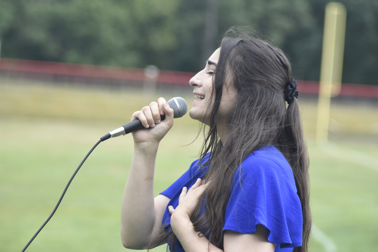 Mariana Barbosa sings the national anthem.   DREW BUDD