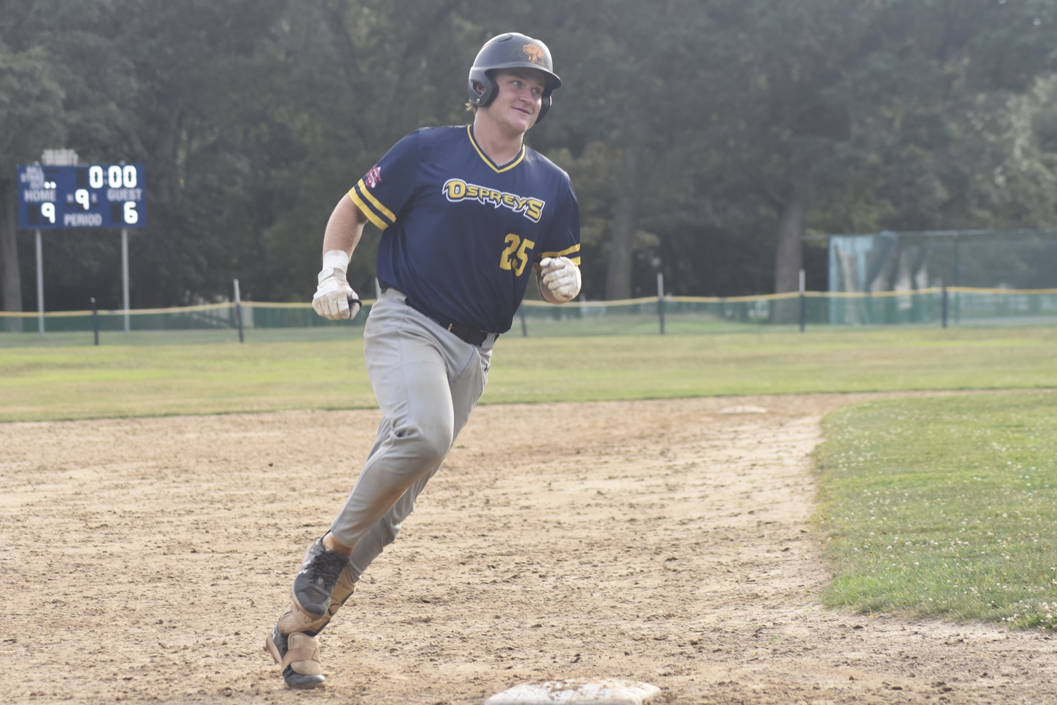 Nick Pratt (Maryland-Baltimore) sees his teammates waiting for him at home plate as he rounds third base on his three-run homer.   DREW BUDD