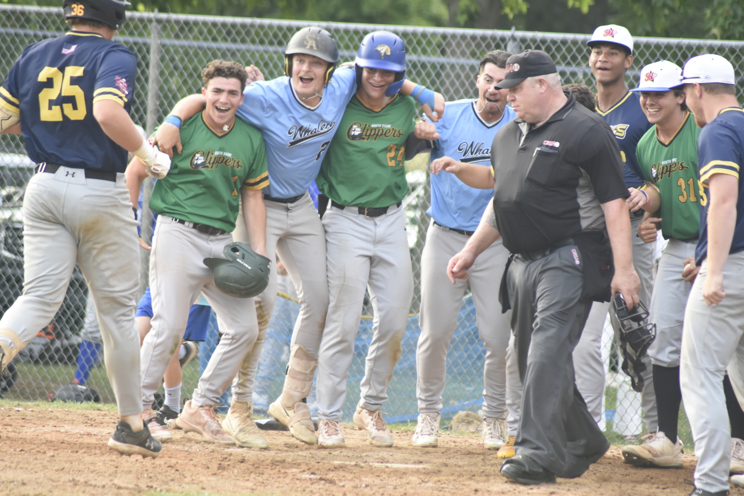 The Blue Team waits for Nick Pratt to touch home plate to celebrate their 9-6 come-from-behind win.  DREW BUDD