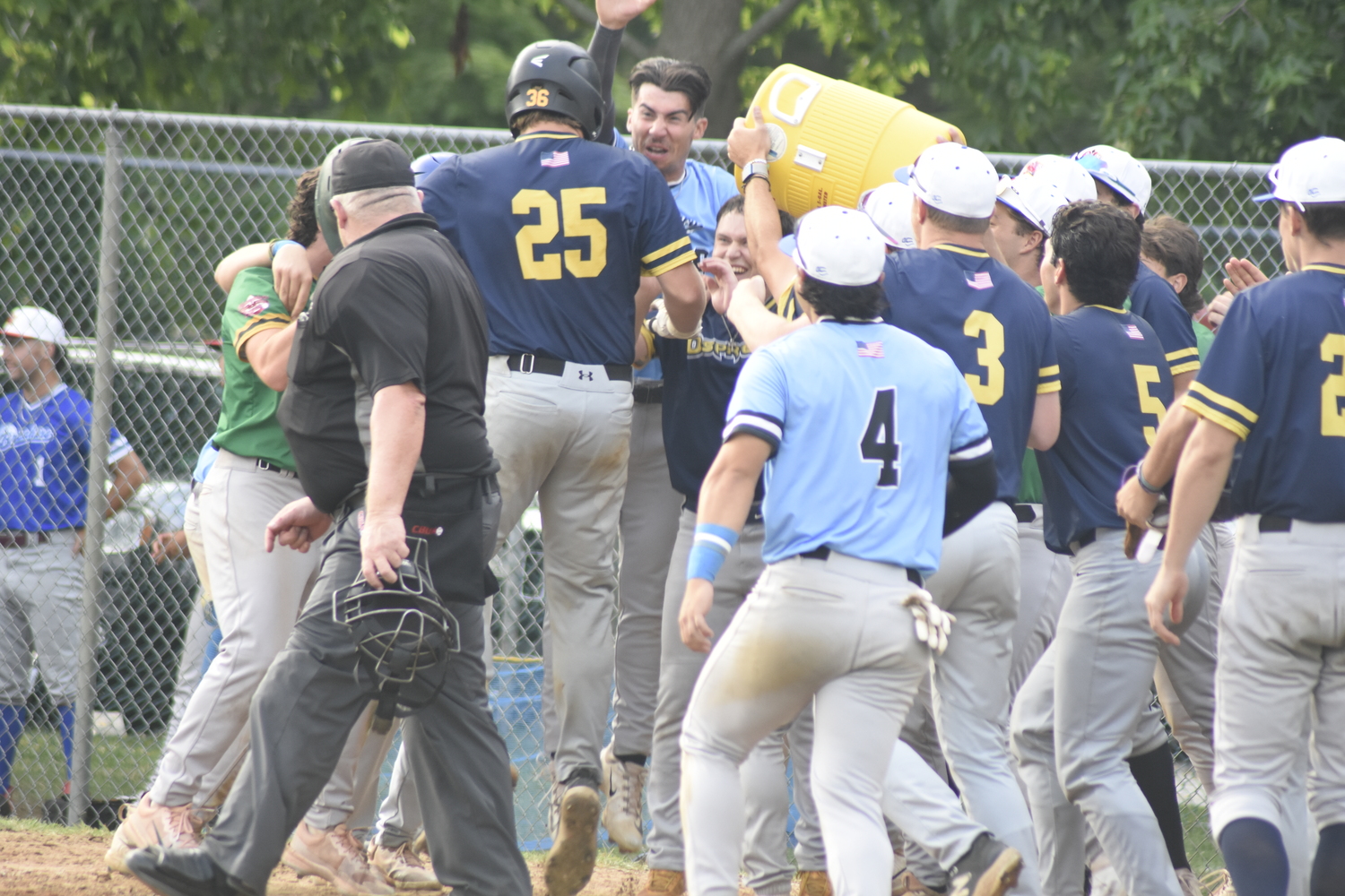 Nick Pratt's Blue Team All-Star teammates douse him in water at home plate.  DREW BUDD