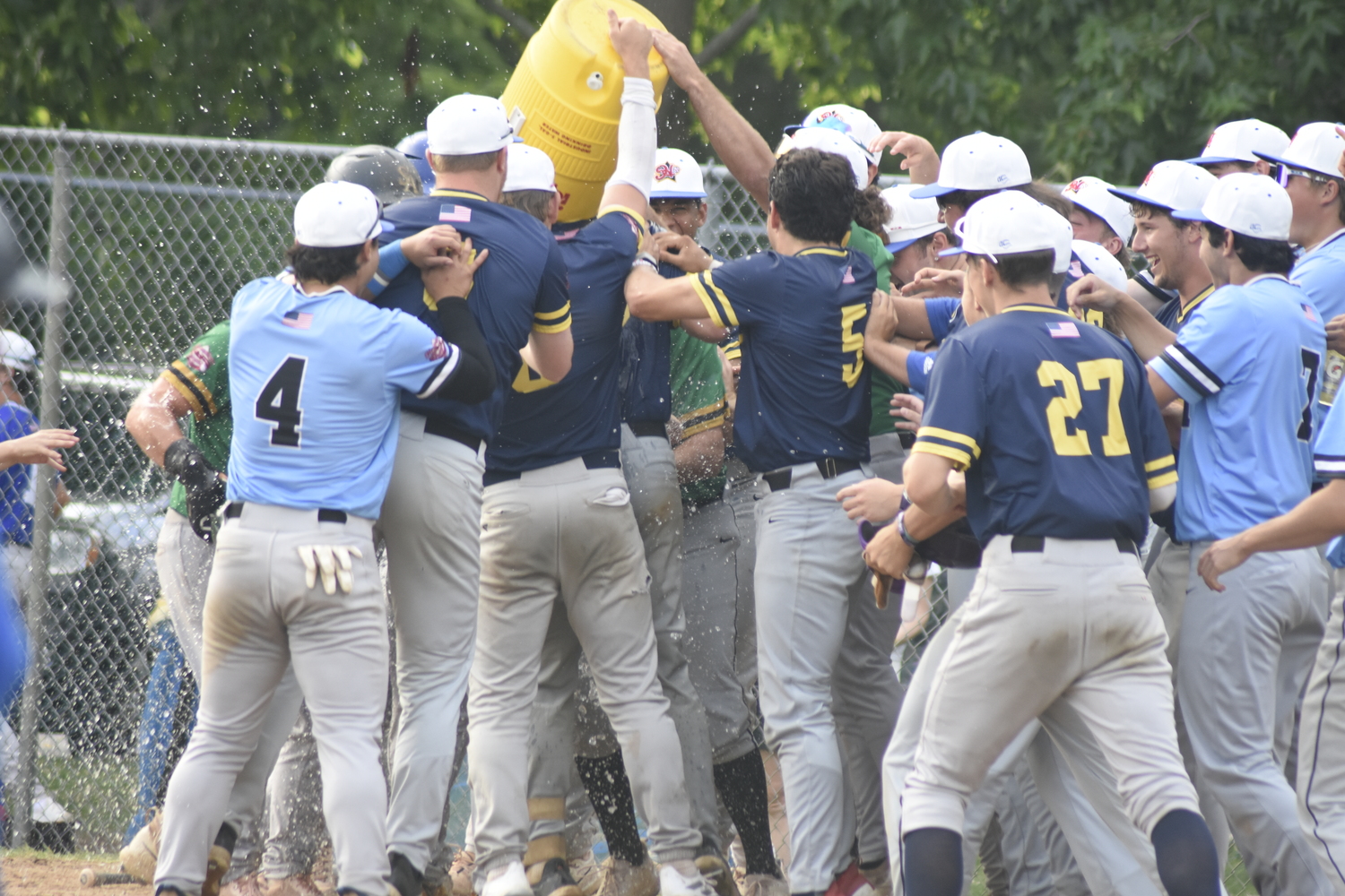 Nick Pratt's Blue Team All-Star teammates douse him in water at home plate.  DREW BUDD