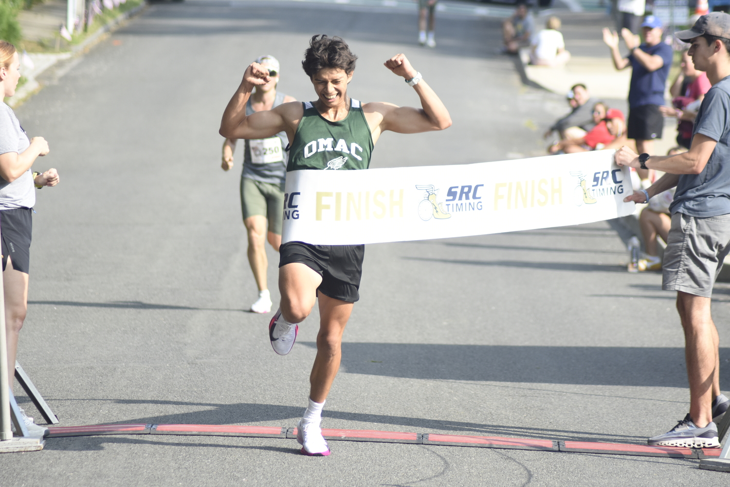 Edmar Gonzalez-Nateras is ecstatic as he crosses the finish line in first place on Sunday morning.   DREW BUDD