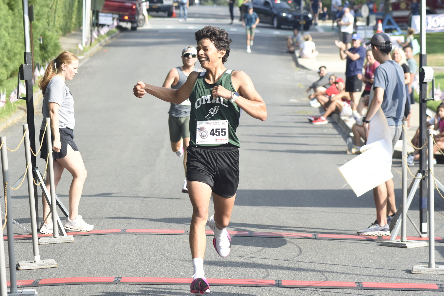 Edmar Gonzalez-Nateras is ecstatic as he crosses the finish line in first place on Sunday morning.   DREW BUDD