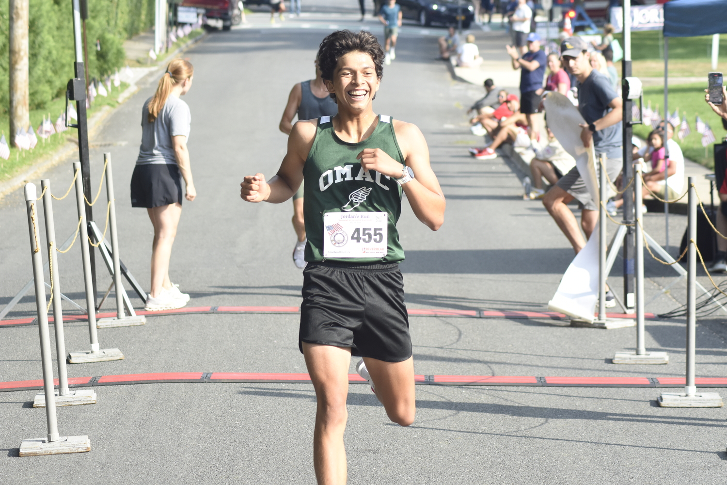 Edmar Gonzalez-Nateras is ecstatic as he crosses the finish line in first place on Sunday morning.   DREW BUDD