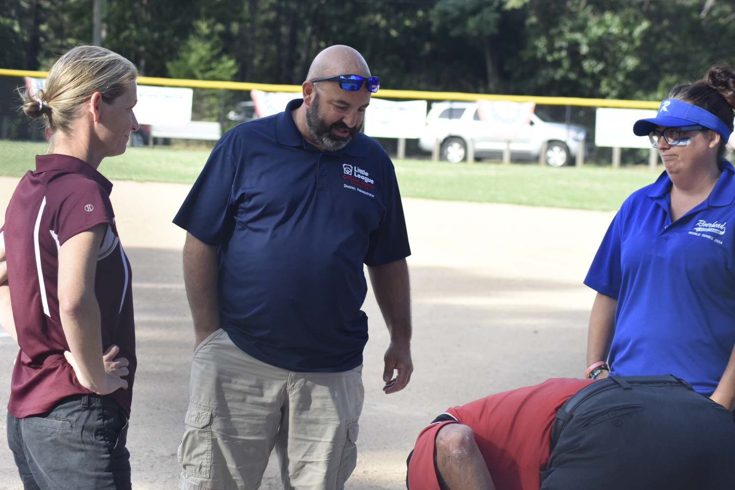 Managers and officials go over the ground rules just prior to Wednesday's District 36 10U softball championships between East Hampton and Riverhead at Stotzky Park.   DREW BUDD