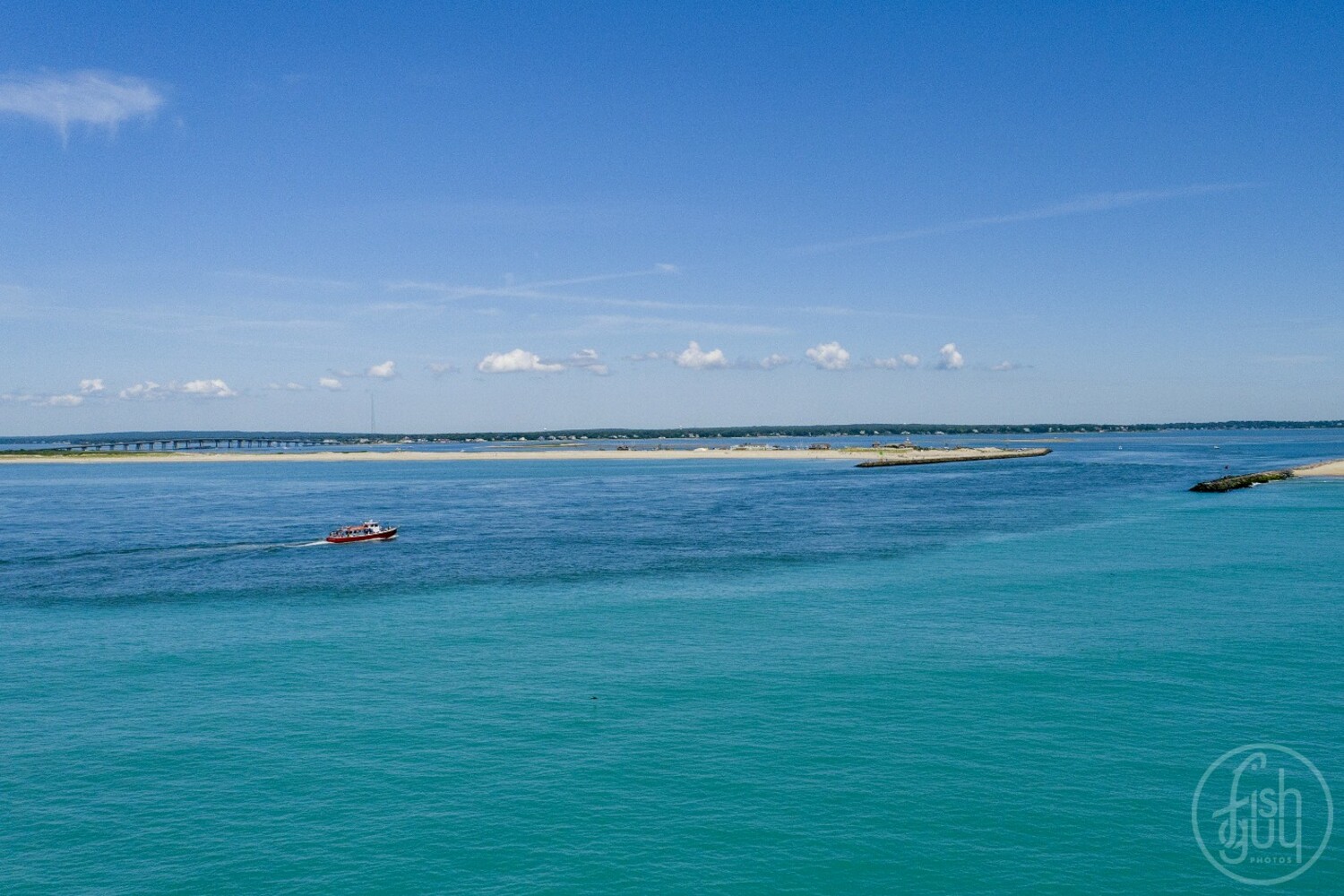 Marine scientists believe that a rare bloom of oceanic phytoplankton is the reason for the turquoise color of the ocean off the Long Island's coastline in recent weeks. On the outgoing tide, the contrast in water color between the ocean and the water coming out of Shinnecock Bay was stark. 
The bloom was likely sparked by sustained strong winds in late June that stirred up nutrients usually on the sea floor, feeding an explosion in the numbers of a specific species of plankton that have a chalky calcium exoskeleton and have been known to tint waters a similar color in other areas. 
CHRIS PAPARO/@FishGuyPhotos