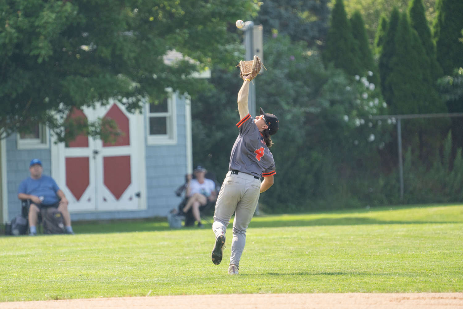 Shelter Island shortstop A.J. Cook (Elms College) goes back to snag a fly ball.   RON ESPOSITO