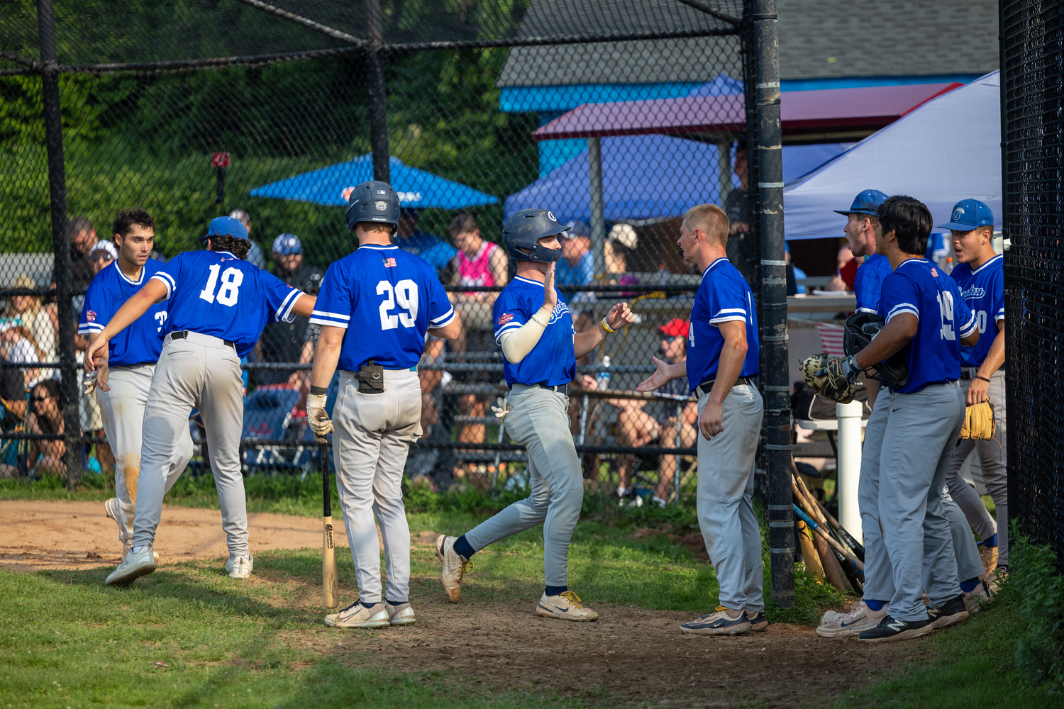 The Breakers congratulate base runners after they score.   RON ESPOSITO