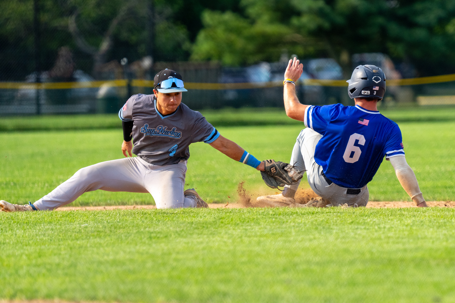 Jack Gold (Pomona-Pitzer) tries to tag out Jaxon Murphy (Cal-Davis) who steals second base.   RON ESPOSITO