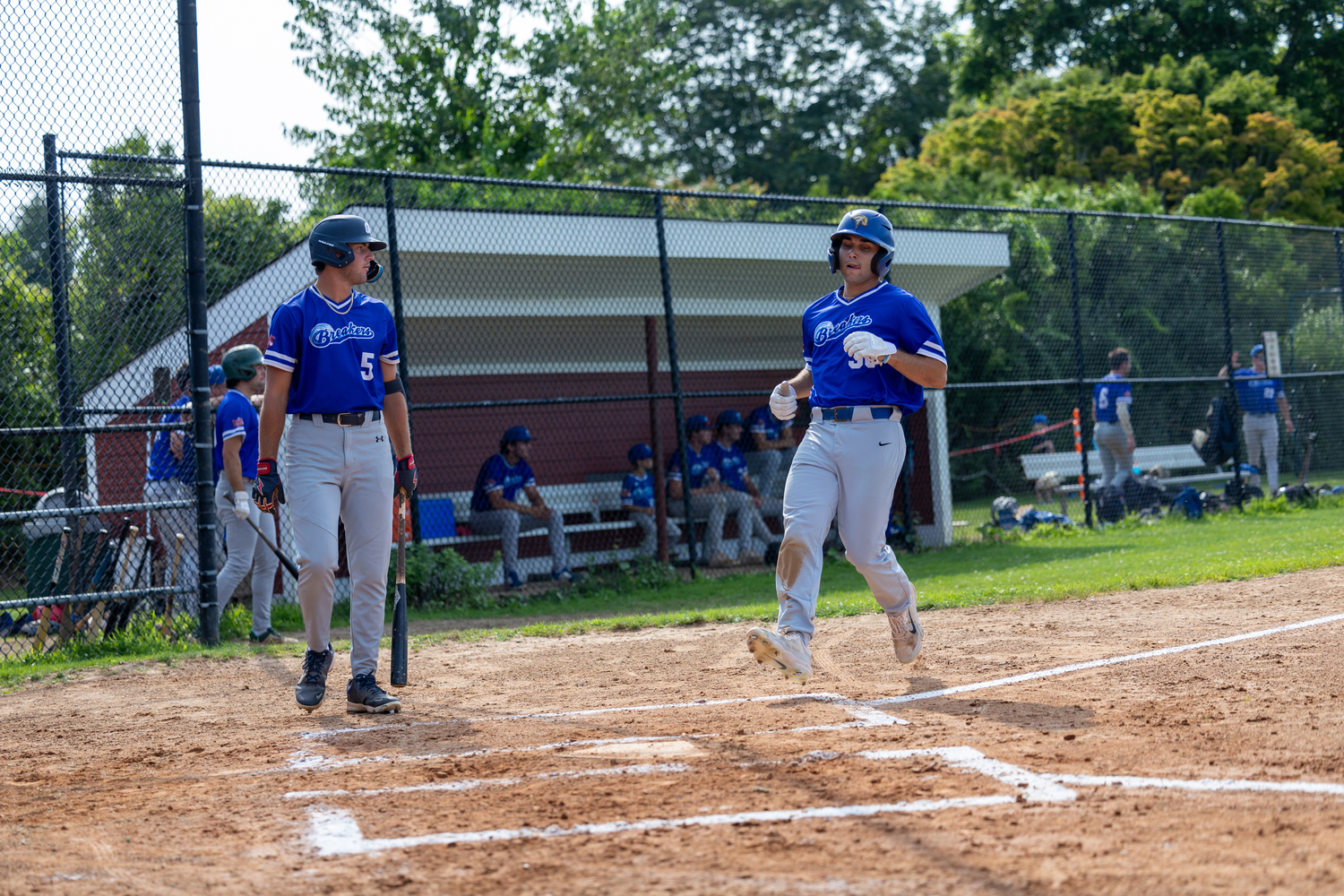 Cole Maucere (New Haven University) comes in to score a run for the Breakers.   RON ESPOSITO