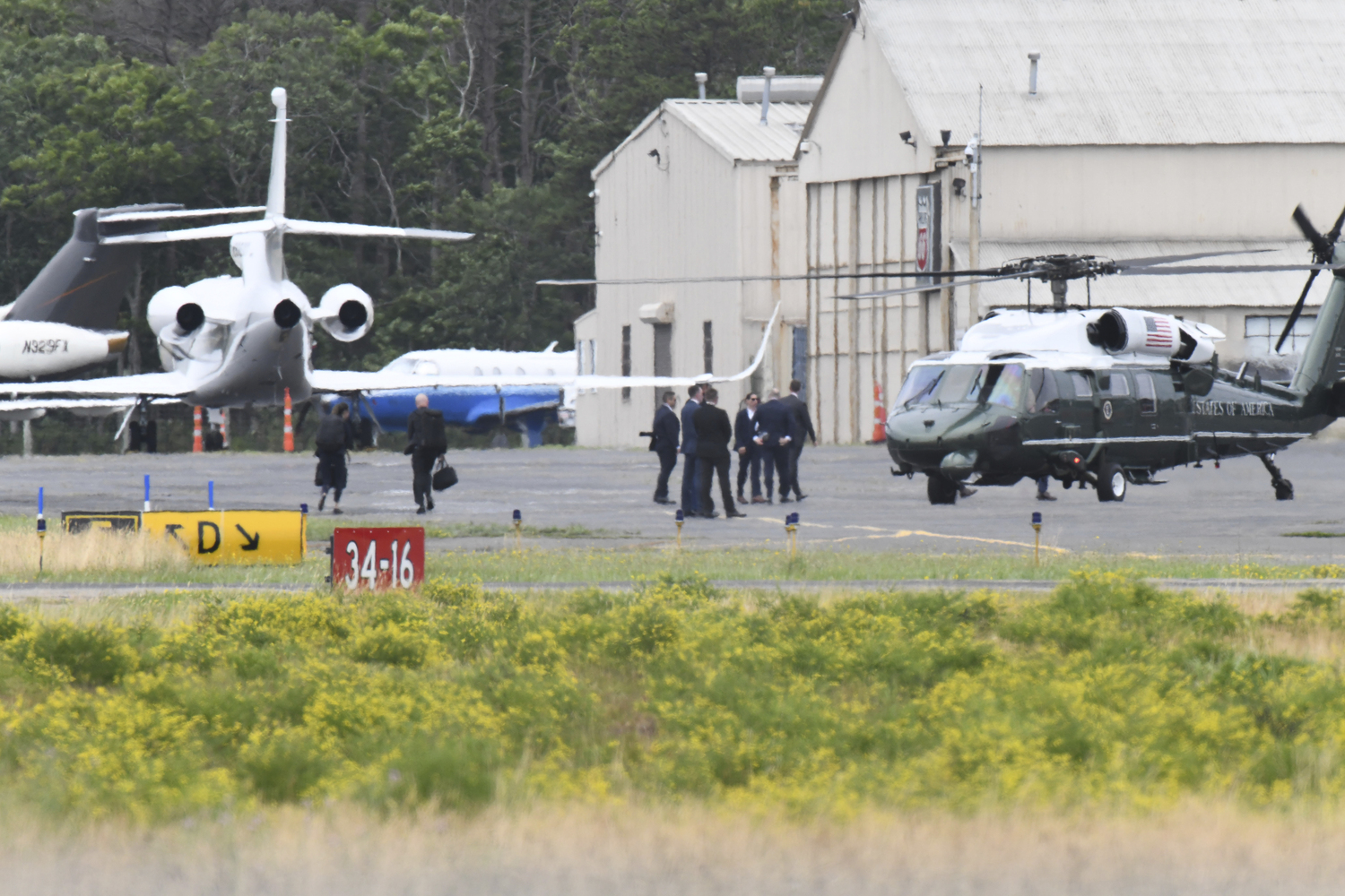 Marine One lands at East Hampton Airport on Saturday afternoon.   DOUG KUNTZ