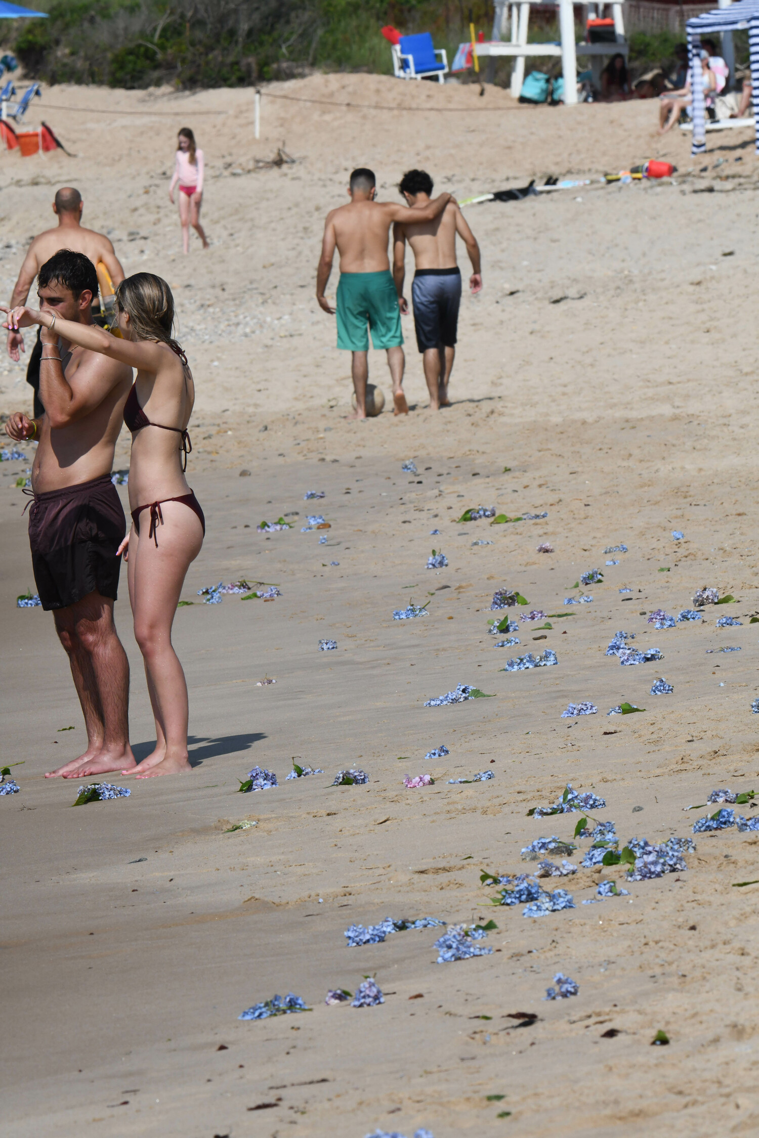 Those in attendance leave flowers in the water to remember those lost. DOUG KUNTZ