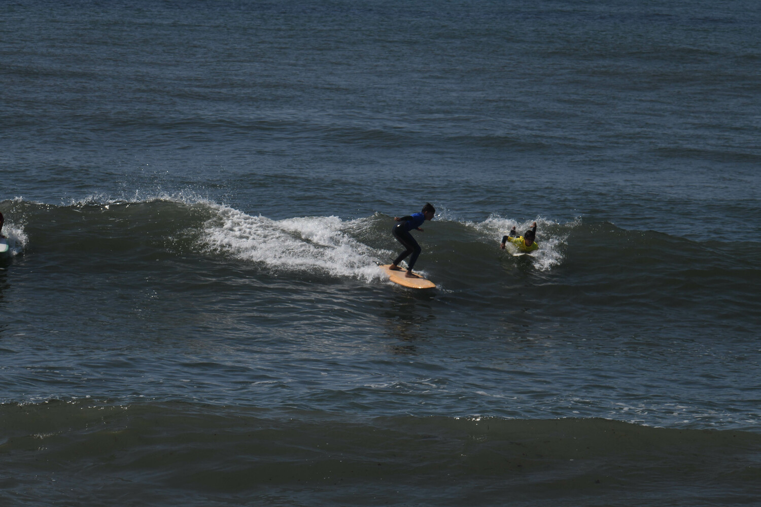 Young surfers trying to catch a wave at Ditch Plains. DOUG KUNTZ