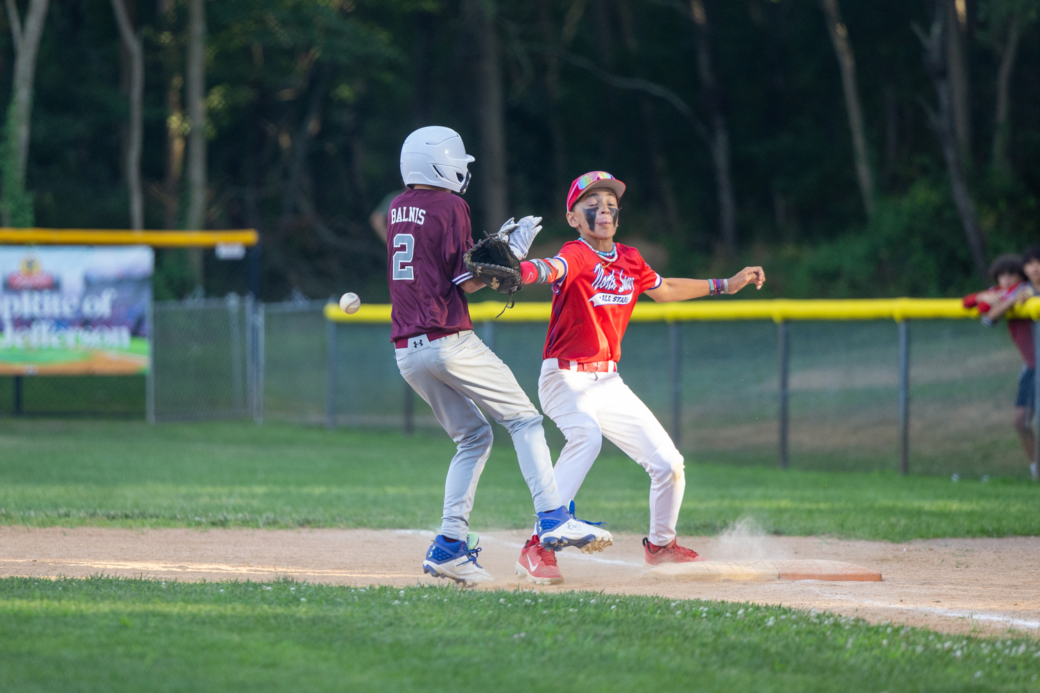 James Balnis retreats back to first as the ball gets away from a North Shore player. Balnis headed to second on the errant throw.   RON ESPOSITO