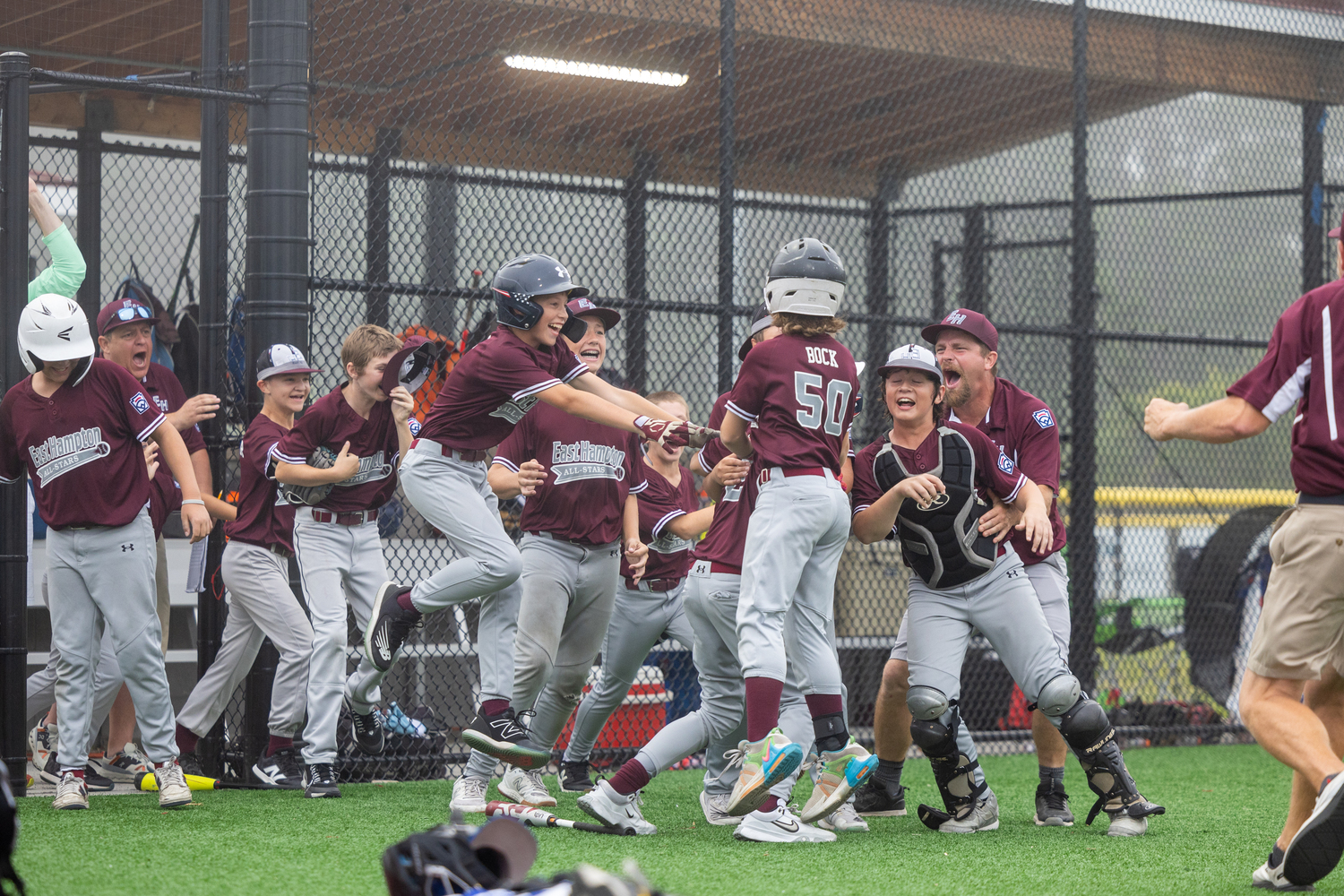 James Balnis is mobbed by his teammates after scoring the game-winning run on a wild pitch in the bottom of the sixth inning of Monday's District 36 semifinal.   RON ESPOSITO