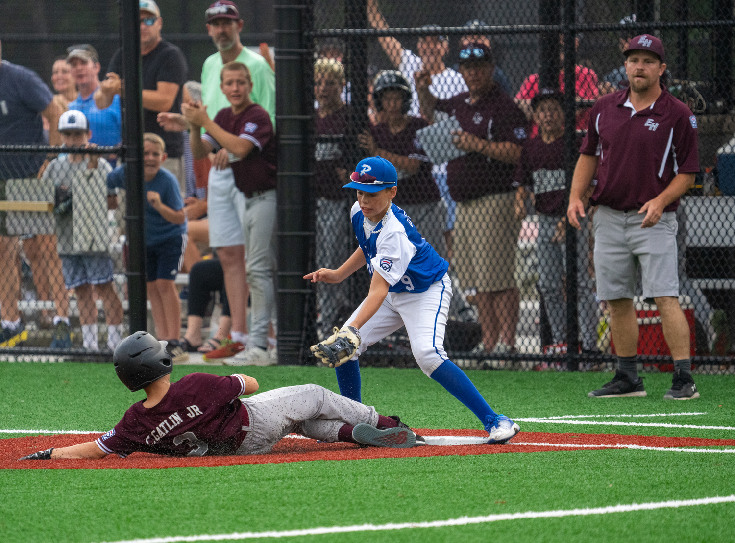 Carl Gatlin slides safely into third base.  RON ESPOSITO