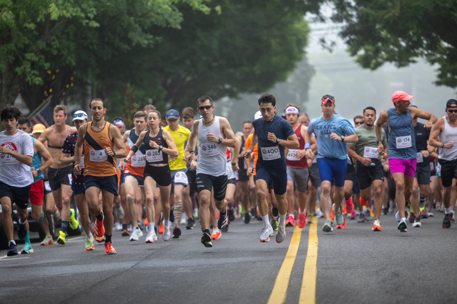 Runners start the 33rd annual Firecracker 8K in Southampton Village on Sunday morning.   RON ESPOSITO