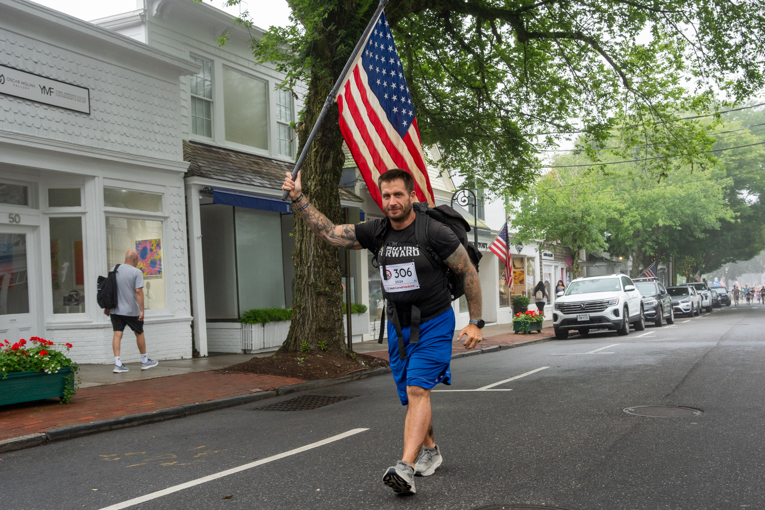 Billy Richards of Bay Shore raises the flag for a race that has become synonymous with the Fourth of July holiday.   RON ESPOSITO