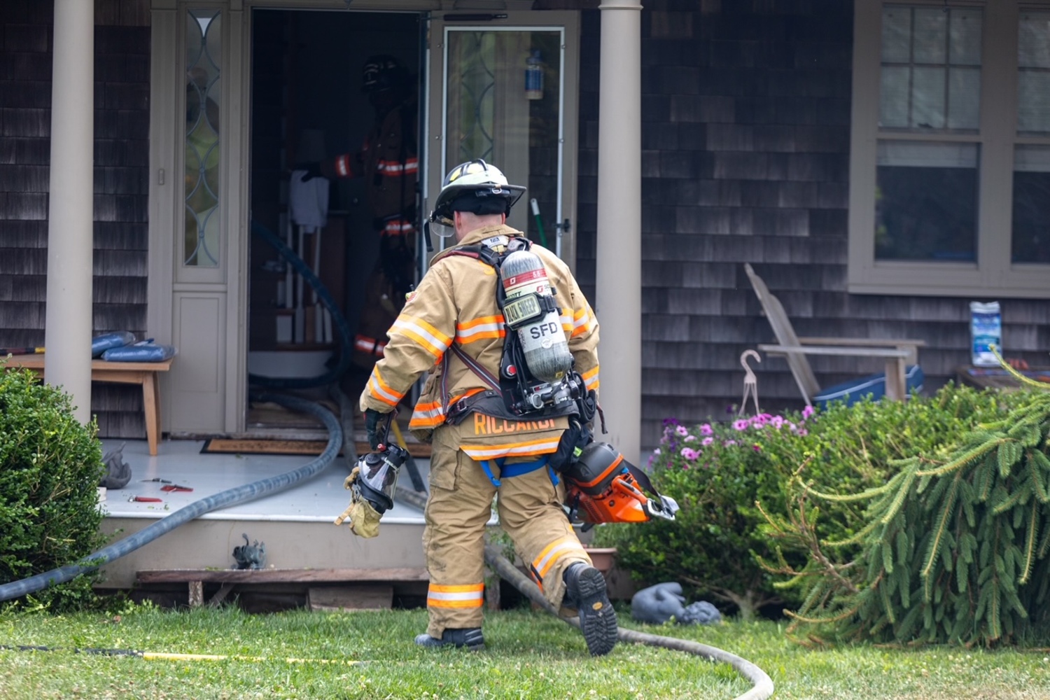 Southampton Fire Department firemen enduring a heat index the pushed over 90 degrees on Friday, extinguised a fire in the eaves a home before they spread. Firefighers were called to the Head of Pond Road home at about 2 p.m. on Friday and found smoke emanating from the attic and fascia of the house. The fire was located and extinguished quickly, the SFD communications officer Chris Brenner said. Firemen from the North Sea and Sag Harbor fire departments also responded to the scene, as did Southampton Volunteer Ambulance and Southampton Village Volunteer Ambulance because the hot weather posed a danger to firemen. The Hampton Bays Fire Department sent crews to standby at Southampton’s stations in case another alarm came in.  JULIAN TAGUE PHOTOS