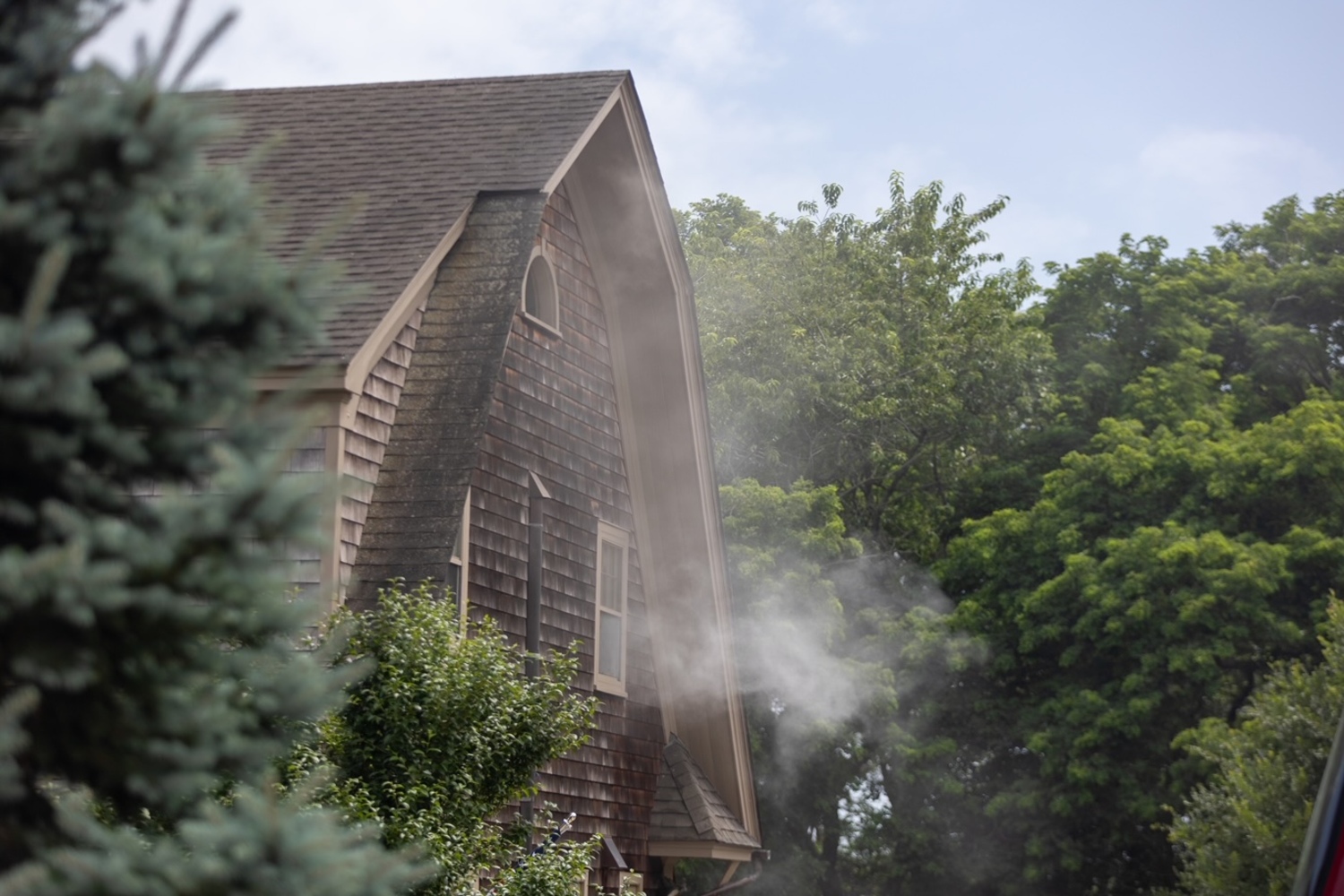 Southampton Fire Department firemen enduring a heat index the pushed over 90 degrees on Friday, extinguised a fire in the eaves a home before they spread. Firefighers were called to the Head of Pond Road home at about 2 p.m. on Friday and found smoke emanating from the attic and fascia of the house. The fire was located and extinguished quickly, the SFD communications officer Chris Brenner said. Firemen from the North Sea and Sag Harbor fire departments also responded to the scene, as did Southampton Volunteer Ambulance and Southampton Village Volunteer Ambulance because the hot weather posed a danger to firemen. The Hampton Bays Fire Department sent crews to standby at Southampton’s stations in case another alarm came in.  JULIAN TAGUE PHOTOS