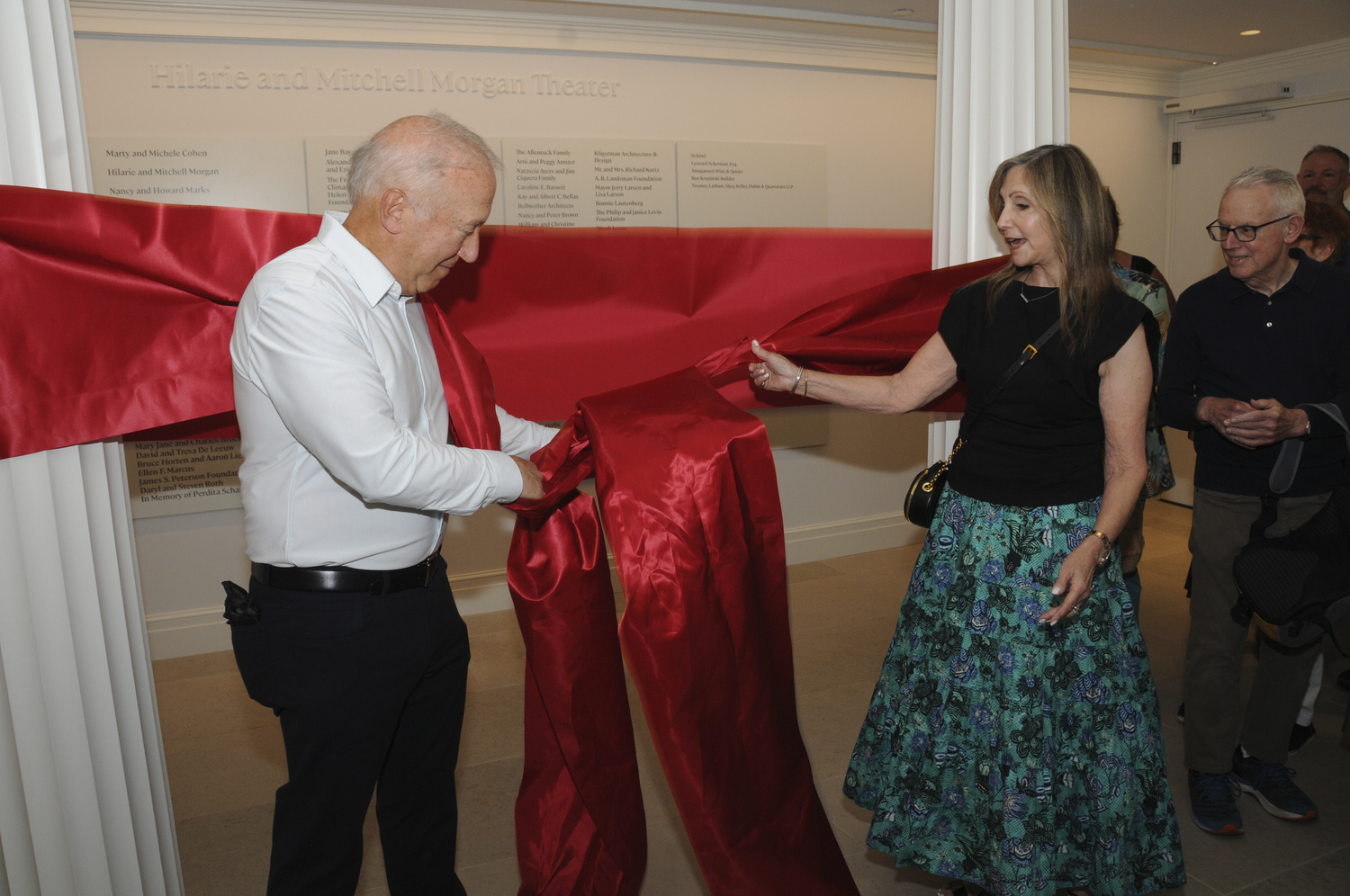 Hilarie and Mitchell  Morgan pull the red ribbon on June 30 officially opening the theater that bears their name, the former Joh Drew theater.   RICHARD LEWIN