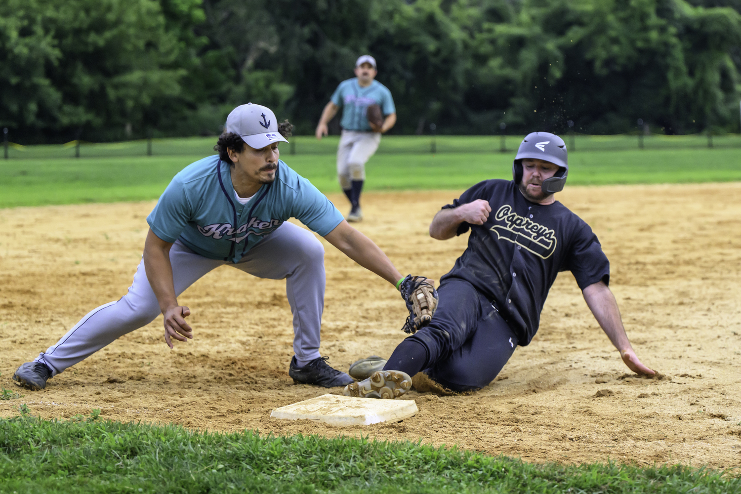 An Ospreys batter gets tagged out at third base,   MARIANNE BARNETT