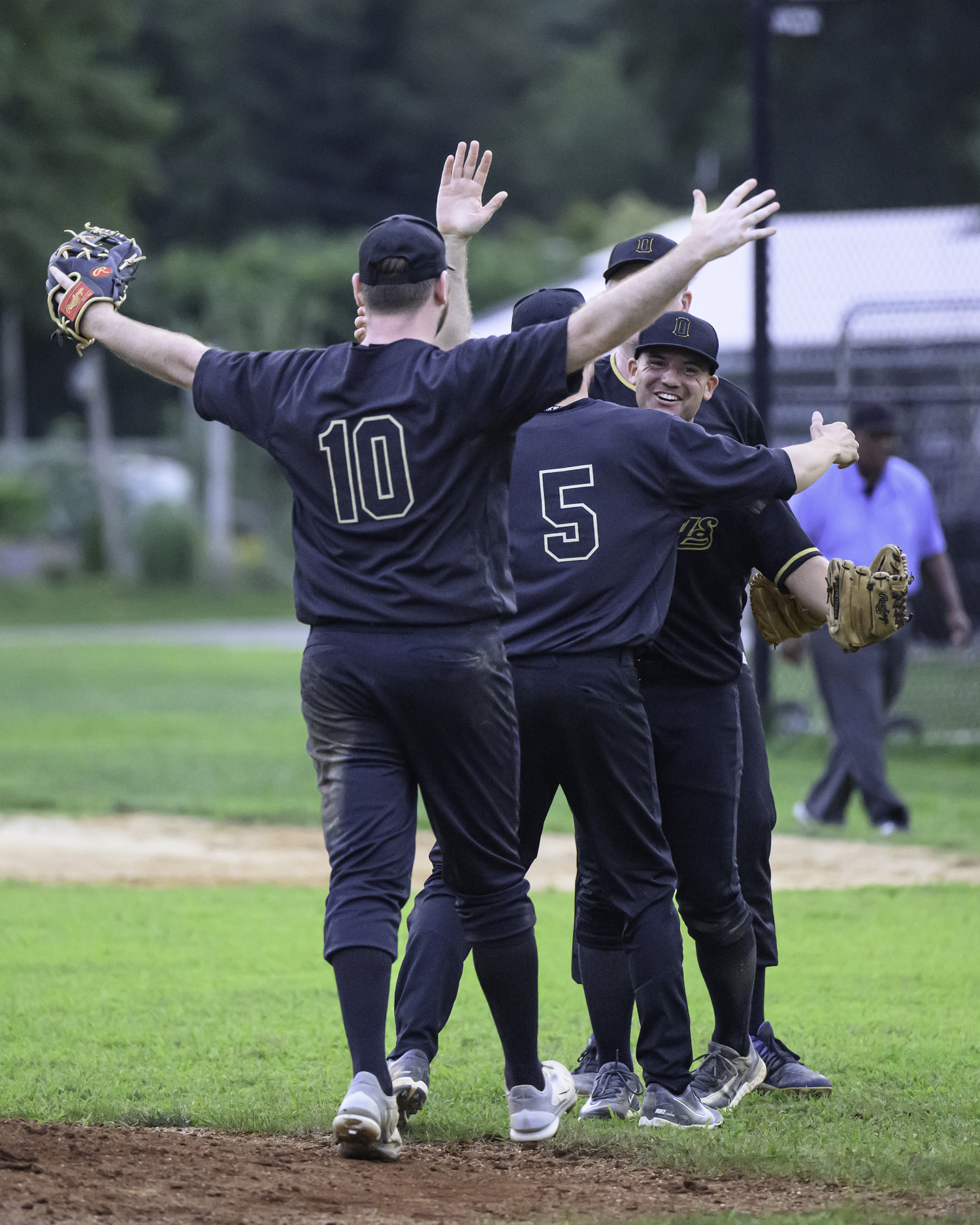 The Ospreys congratulate their pitcher after winning the championship.   MARIANNE BARNETT