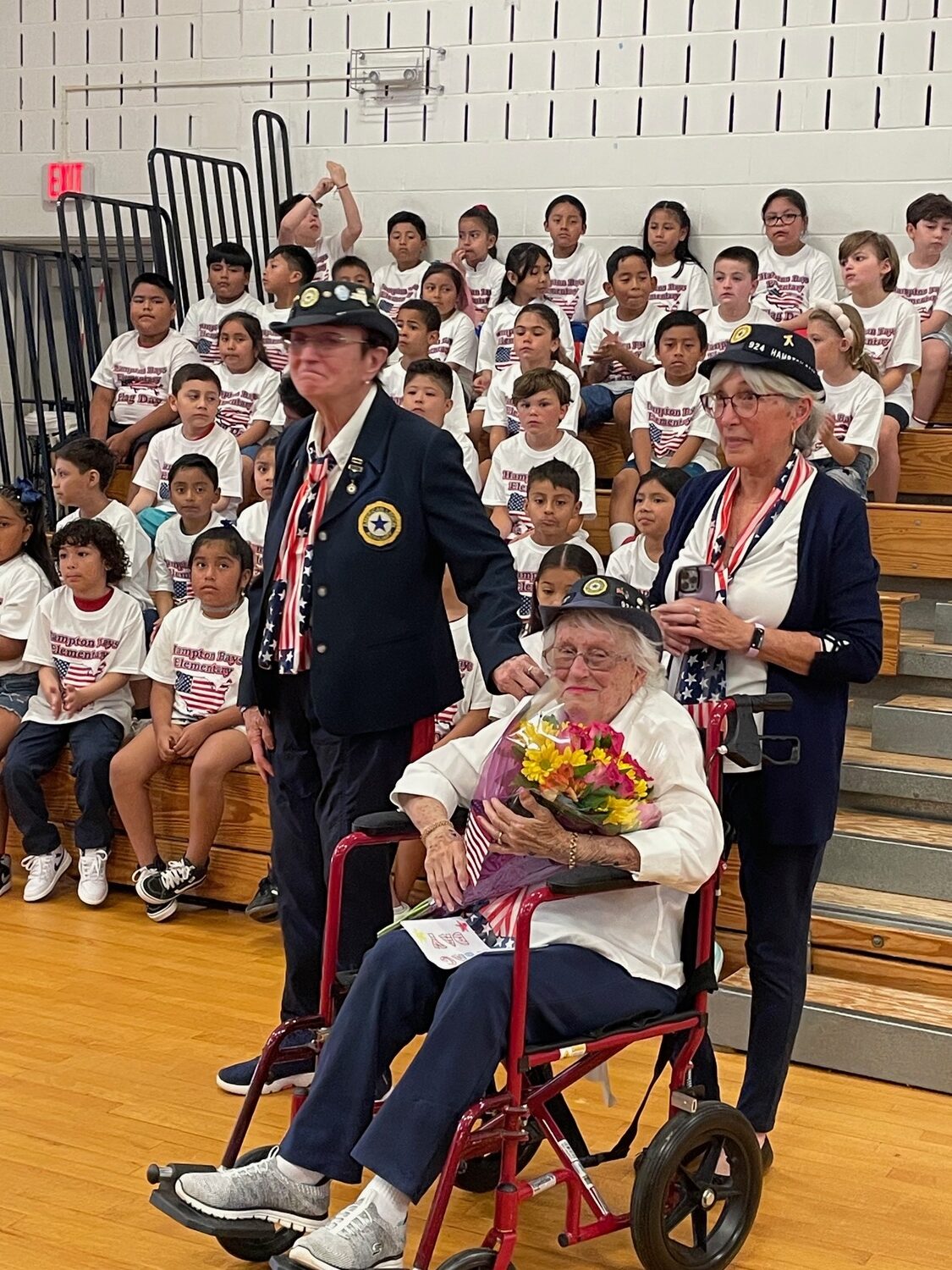 On Flag Day at the Hampton Bays Elementary School,  Superintendent Lars Clemensen honored Sylvia Smith,  99, of the hand Aldrich American Legion Auxiliary Unit 924. Smith will be 100 on September 11 and has attended many of the school district's veterans ceremonies. COURTESY PAM RYAN