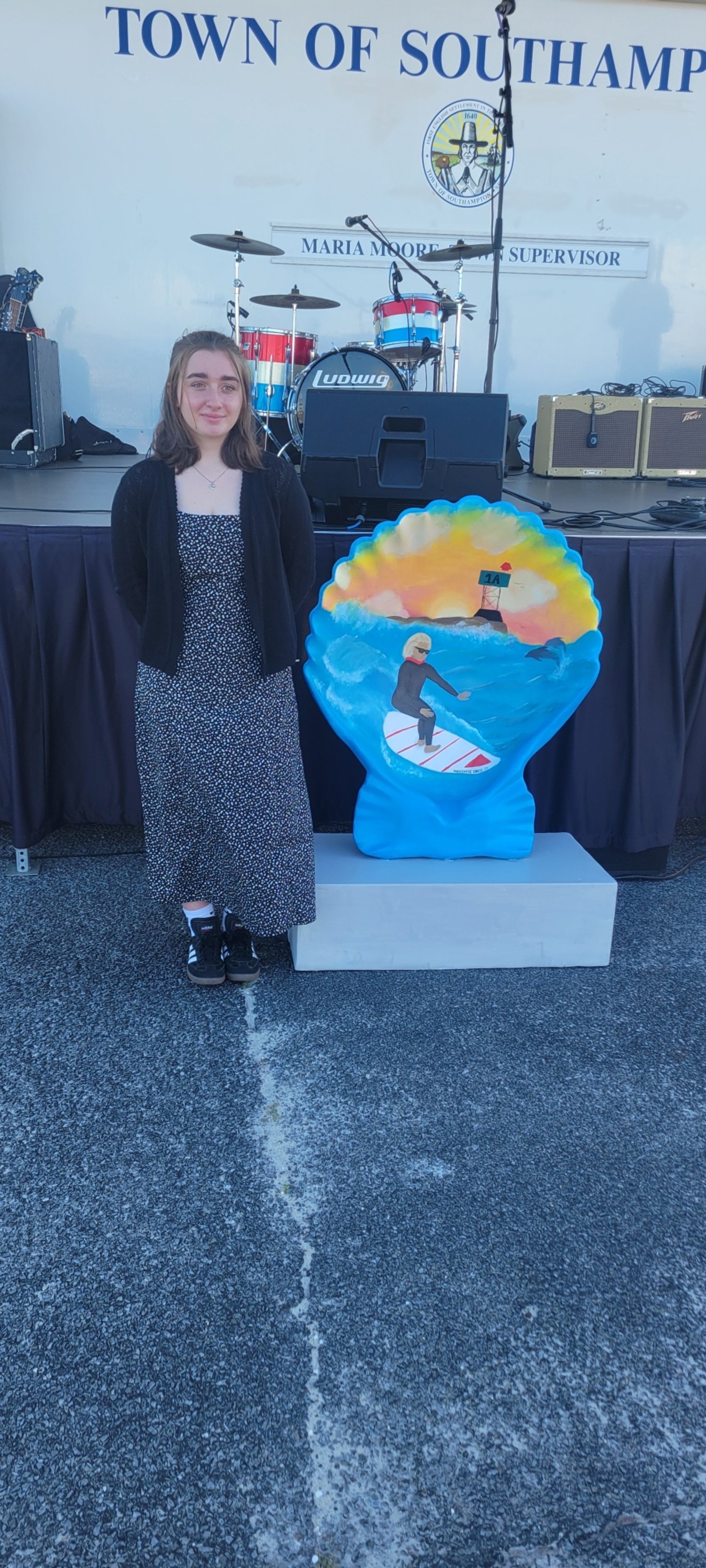 The artwork of Hampton Bays High School student Mackenzie David is now on display as part of a new Hampton Bays Chamber of Commerce communitywide art installation.
The Shell Statue Art Project aims to showcase the Hampton Bays community
through the installation of 32”x40” shell statues painted by Hampton Bays High School students and community artists. A total of 17 statues will be placed at various
locations in the hamlet. David’s painted shell was the first to be unveiled during a ceremony on July 5 at Ponquogue Beach, where it will be permanently installed. It features a surfing theme. Future shells to be placed around the hamlet will feature a variety of other themes. COURTESY HAMPTON BAYS SCHOOL DISTRICT