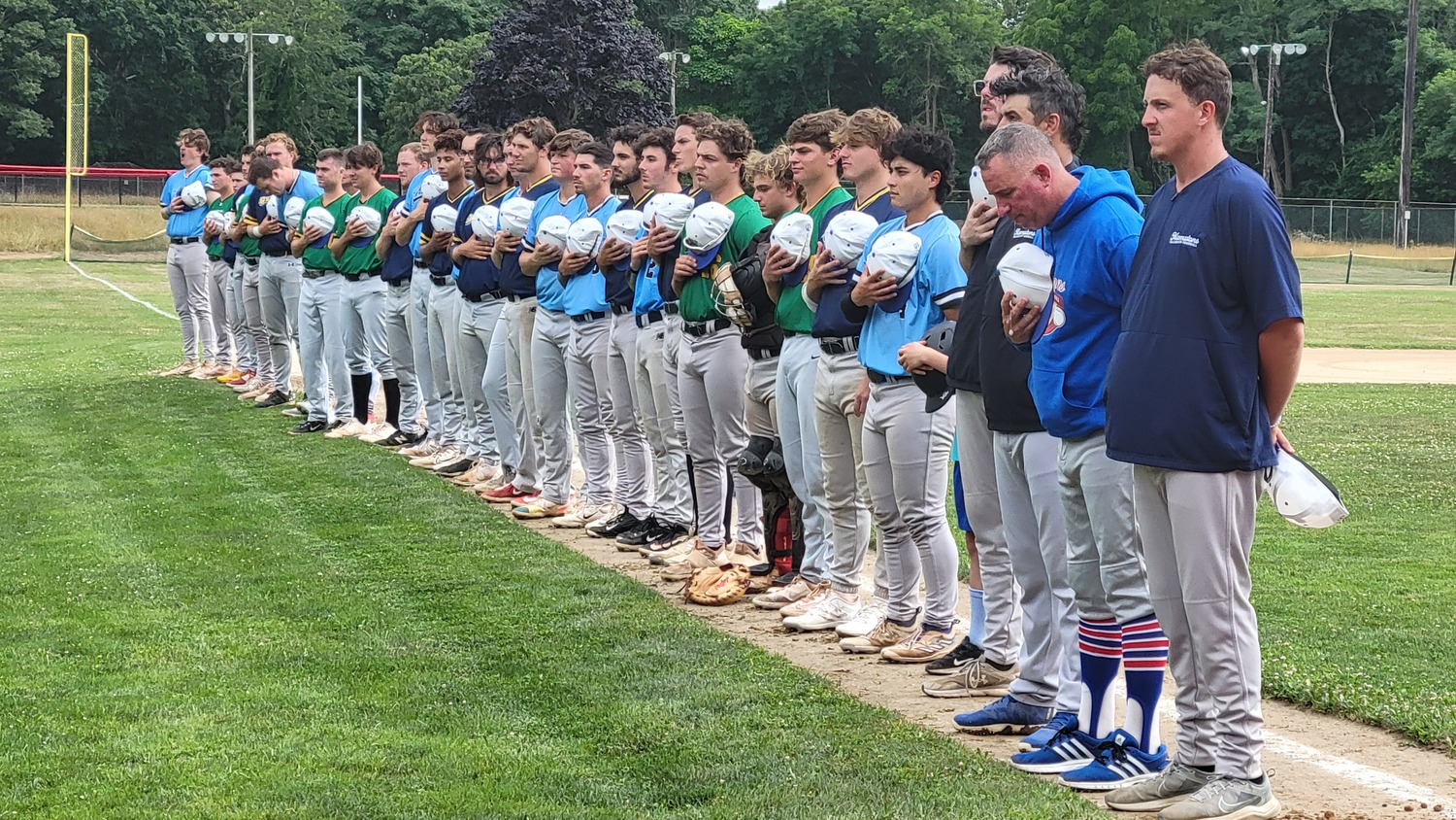 The HCBL Blue Team All-Stars line up along the third base line during pregame festivities on Saturday at Mashashimuet Park in Sag Harbor.  DREW BUDD