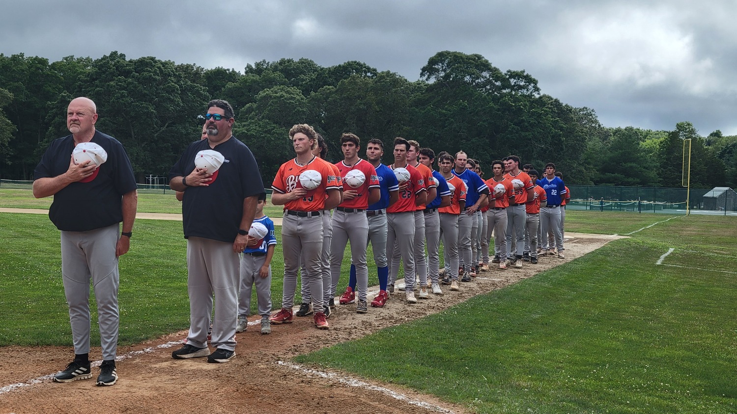 The HCBL Red Team All-Stars line up along the third base line during pregame festivities on Saturday at Mashashimuet Park in Sag Harbor.  DREW BUDD