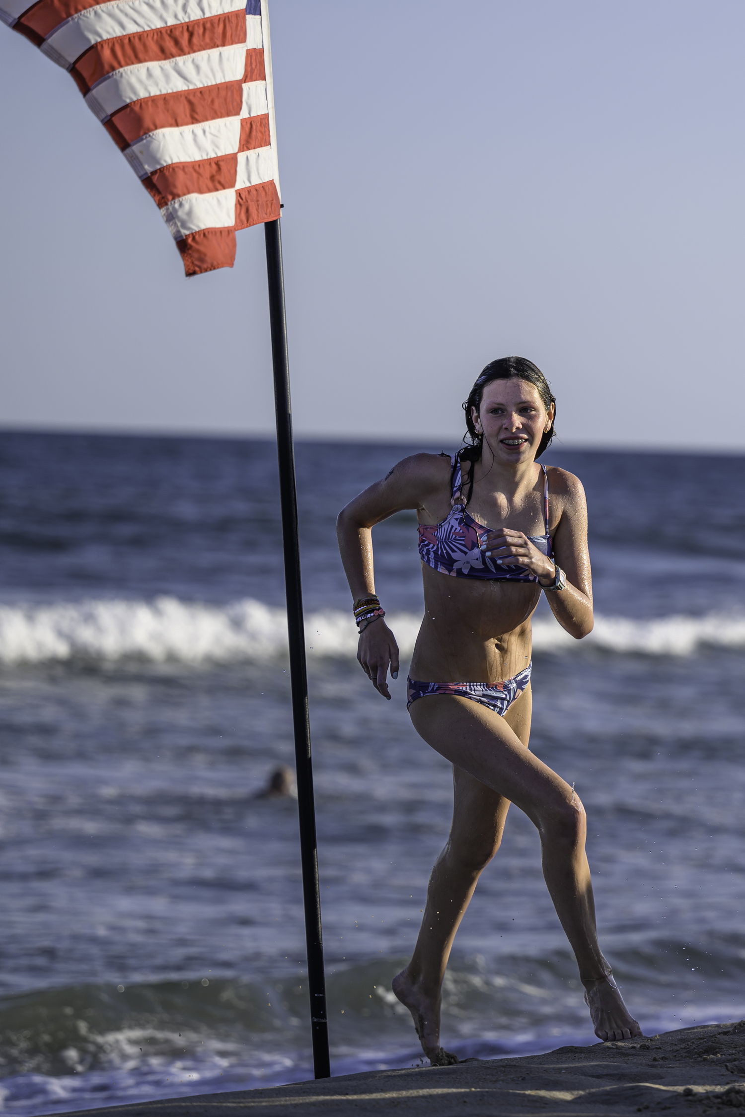 A competitor makes the turn around the American flag.    MARIANNE BARNETT