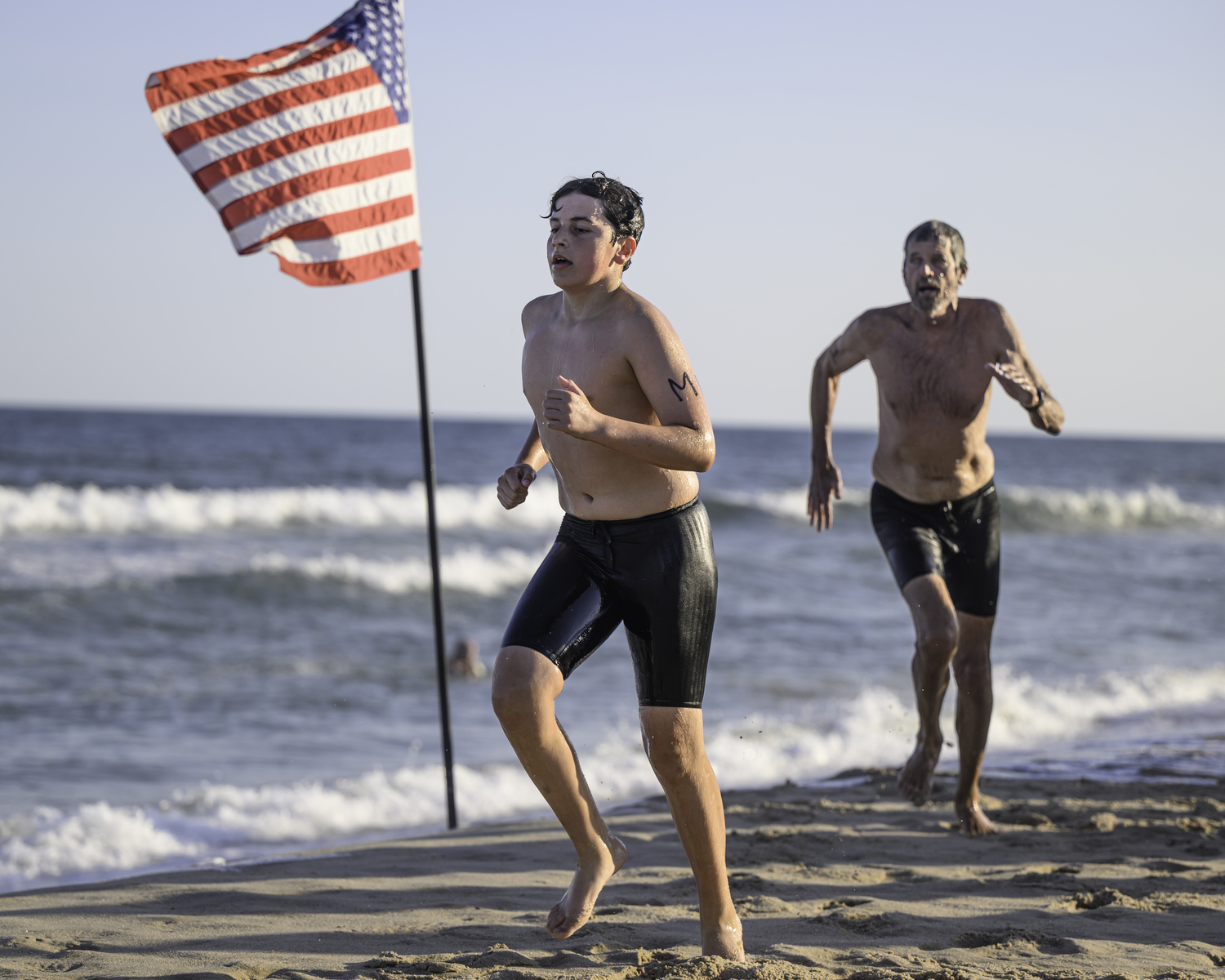 Competitors make the turn around the American flag.    MARIANNE BARNETT