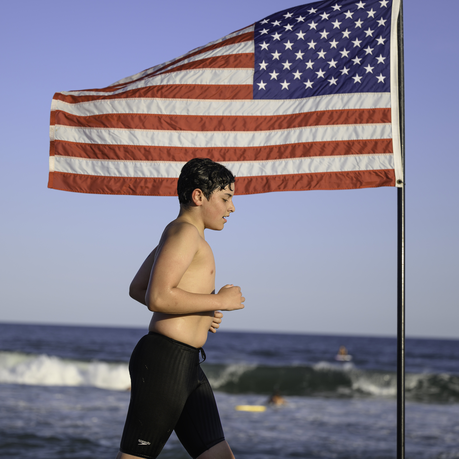 A competitor makes the turn around the American flag.    MARIANNE BARNETT