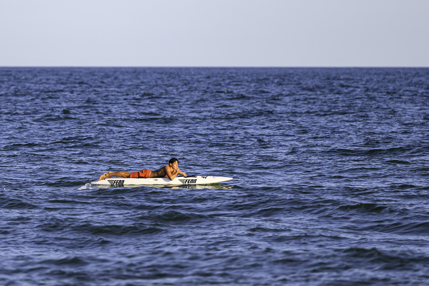 Liam Knight, set to represent HLA at the World Championships next month, patrols the waters on a board.  MARIANNE BARNETT