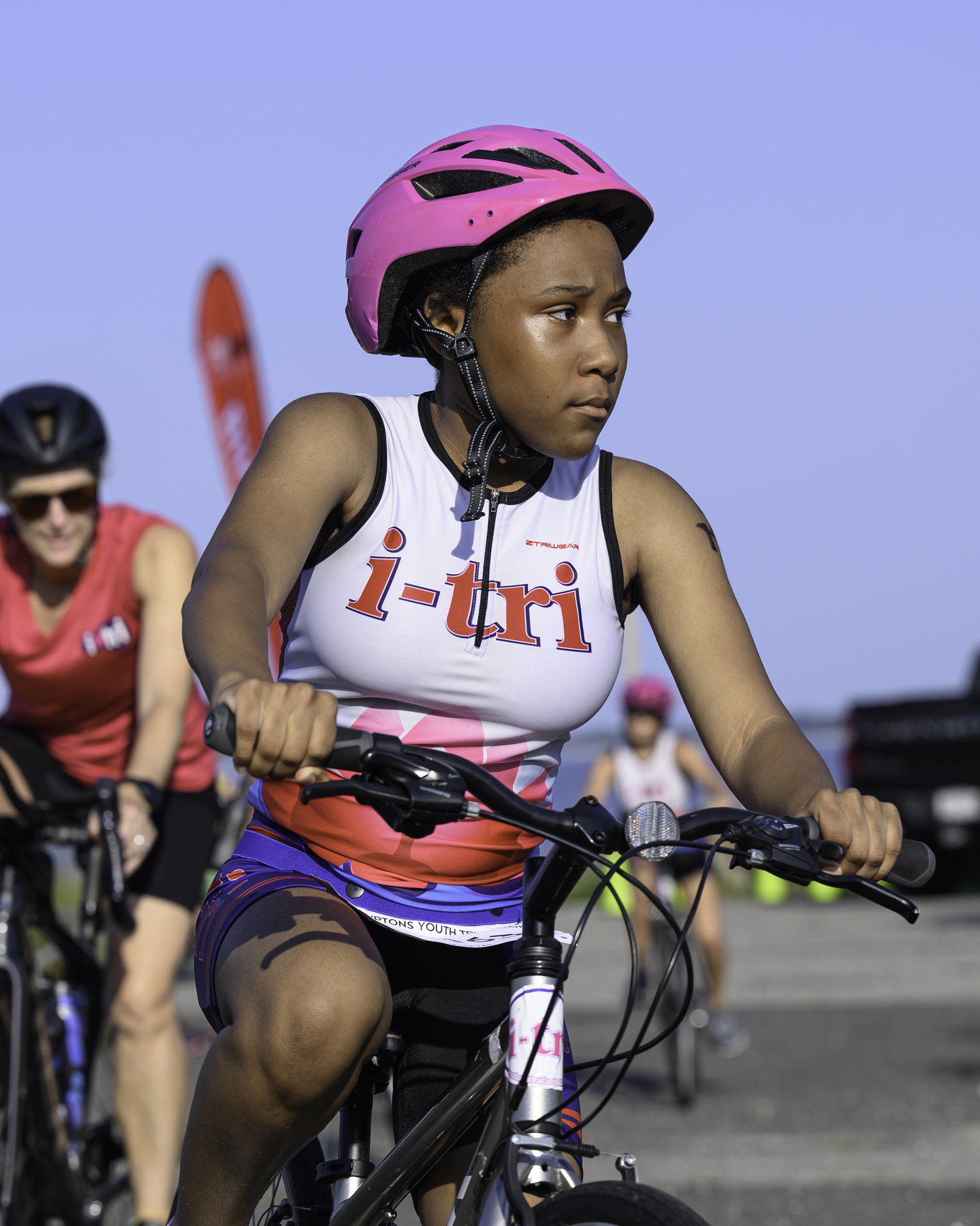 An i-tri girl gets on her bike for the 6-mile ride.  MARIANNE BARNETT