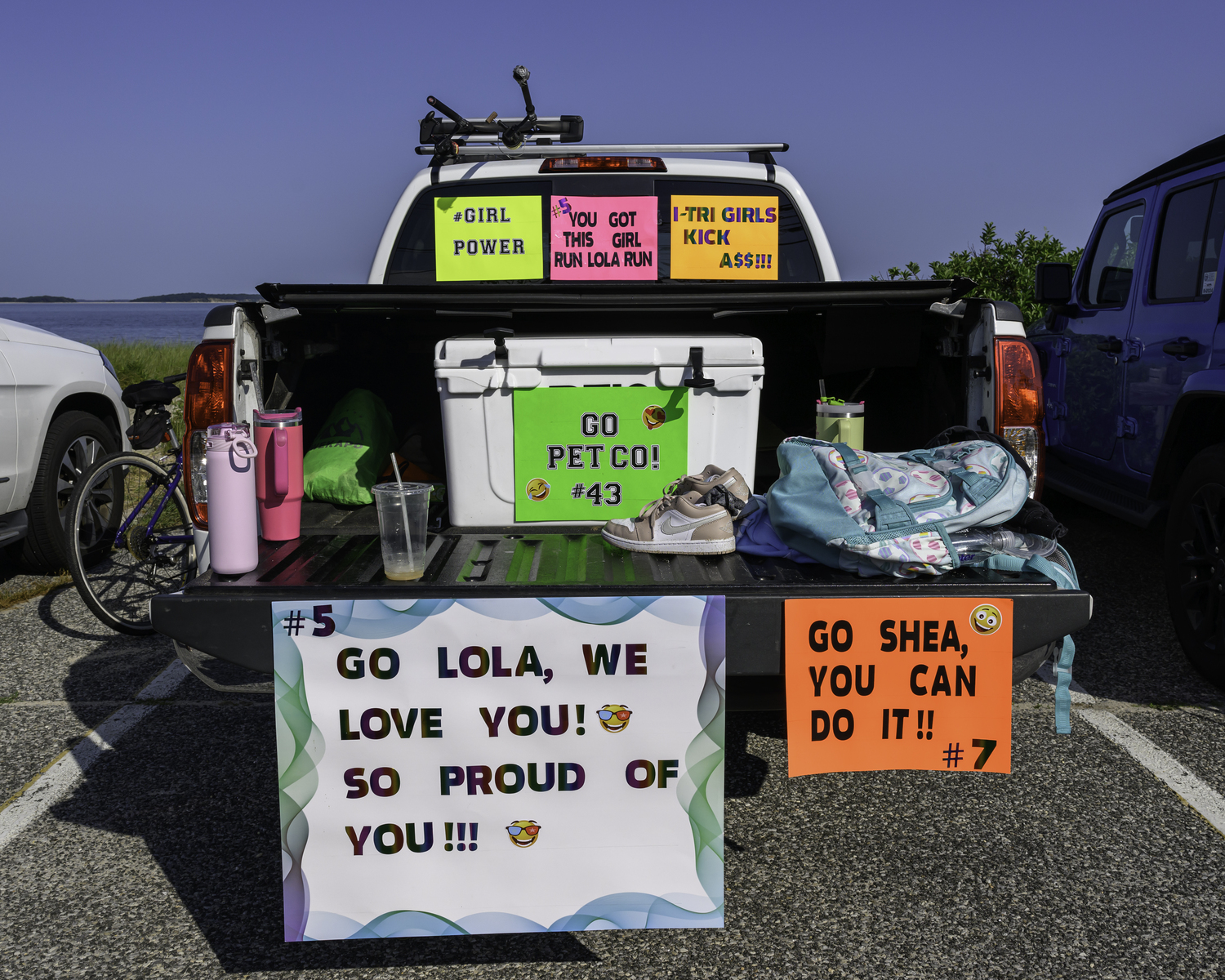 A truck supports many i-tri girls.   MARIANNE BARNETT