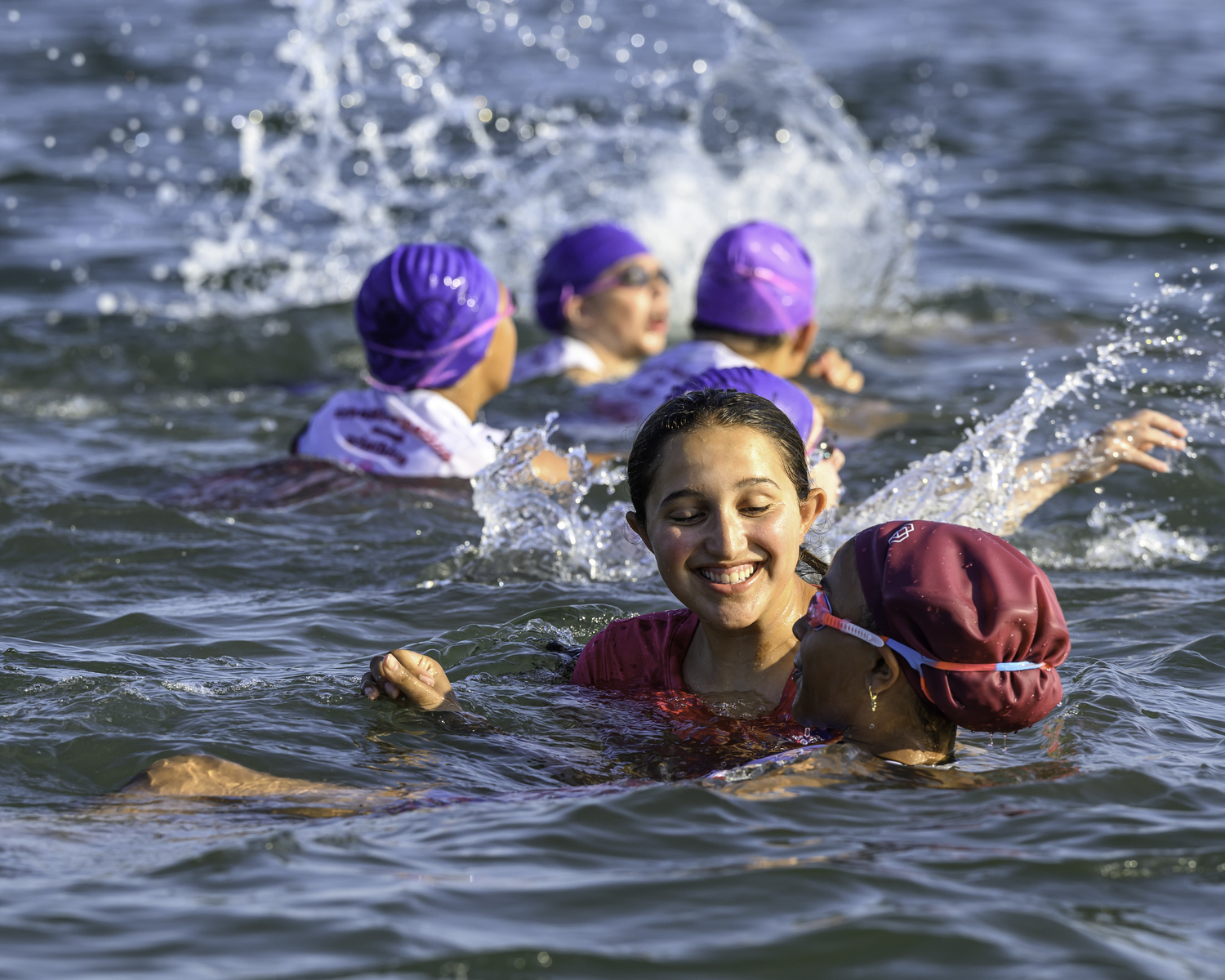 Izzy Caplin supports an i-tri girl during her swim on Sunday.  MARIANNE BARNETT